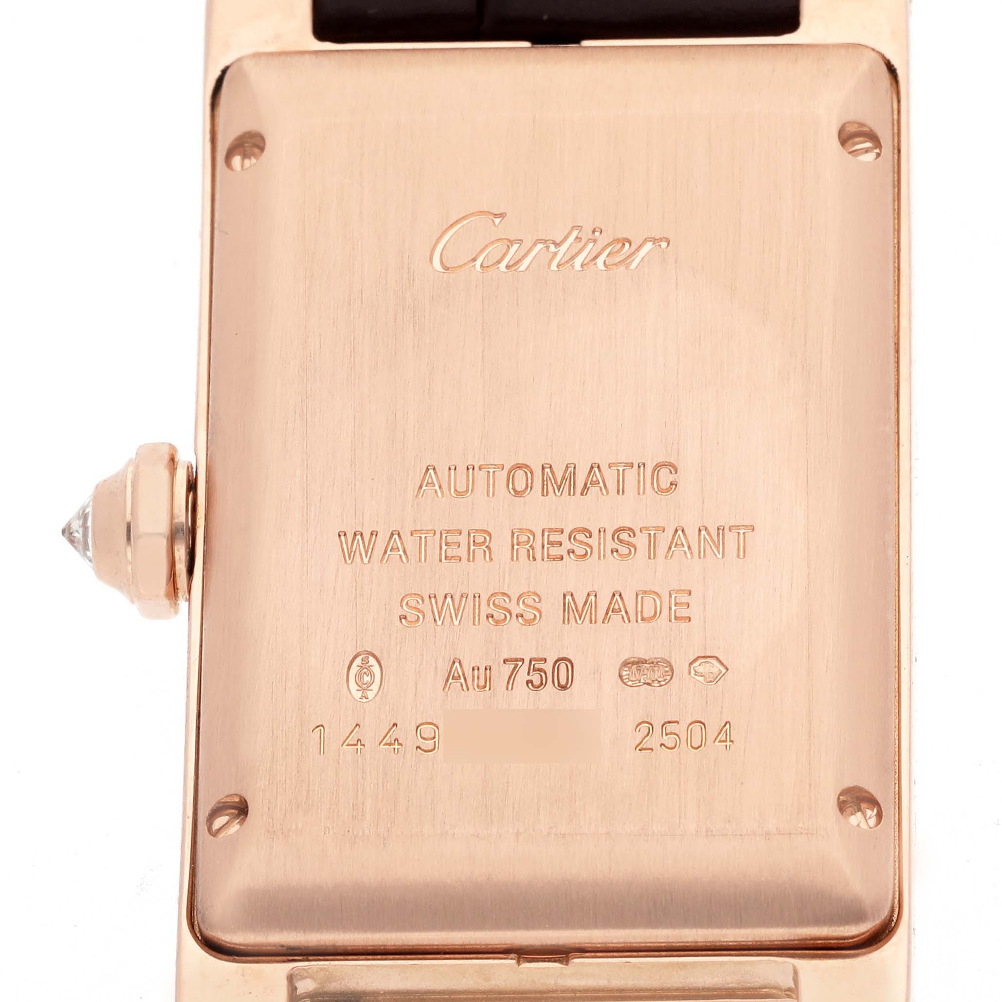 The image shows the back case of the Cartier Tank Americaine WB704751 Women's Rose Gold Silver Dial WB704751 Women's Rose Gold Silver Dial watch, featuring engravings and part of the crown.