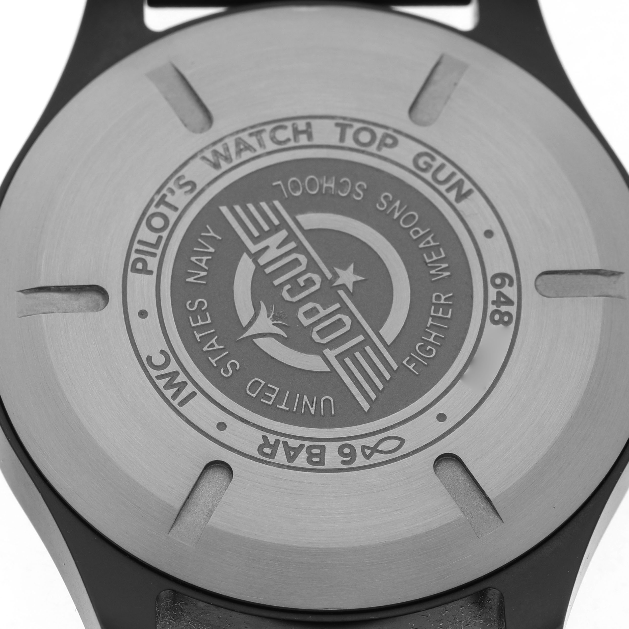 The image shows the case back of an IWC Pilot 84738 Men's Ceramic Black Dial's Watch Top Gun model, featuring engraved branding and specifications.