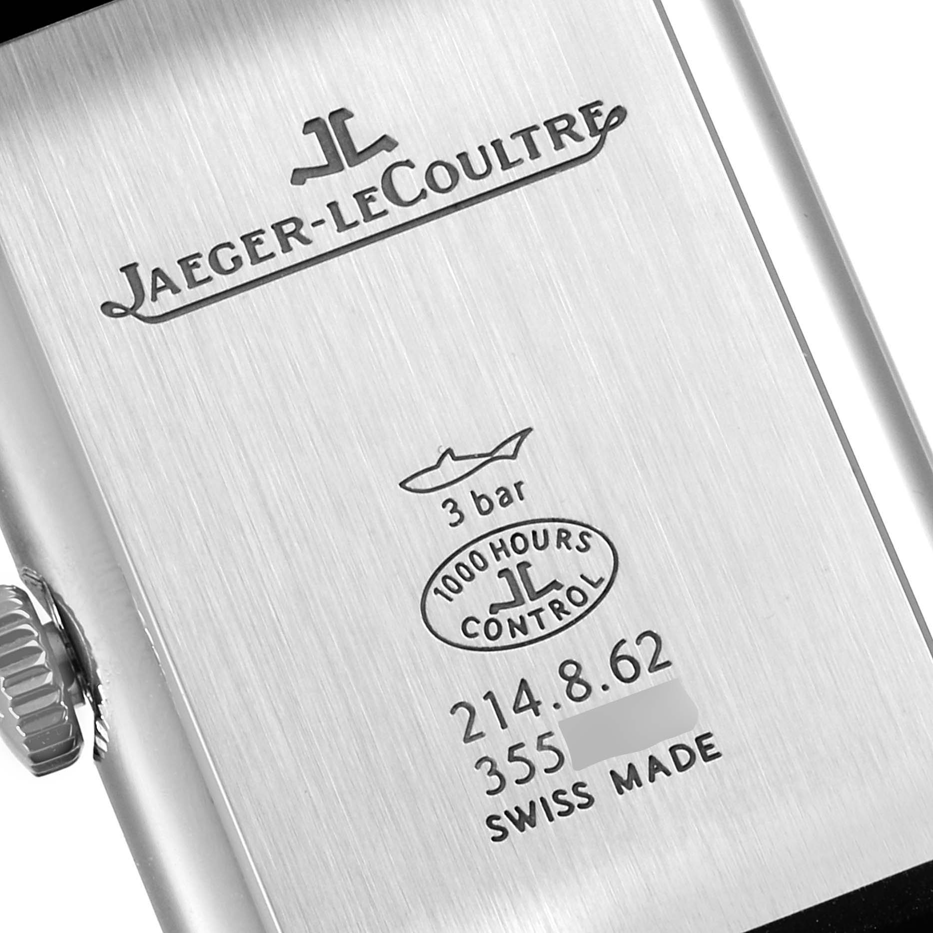 The image shows the back side of a Jaeger-LeCoultre Reverso watch, displaying its engravings, specifications, and branding.