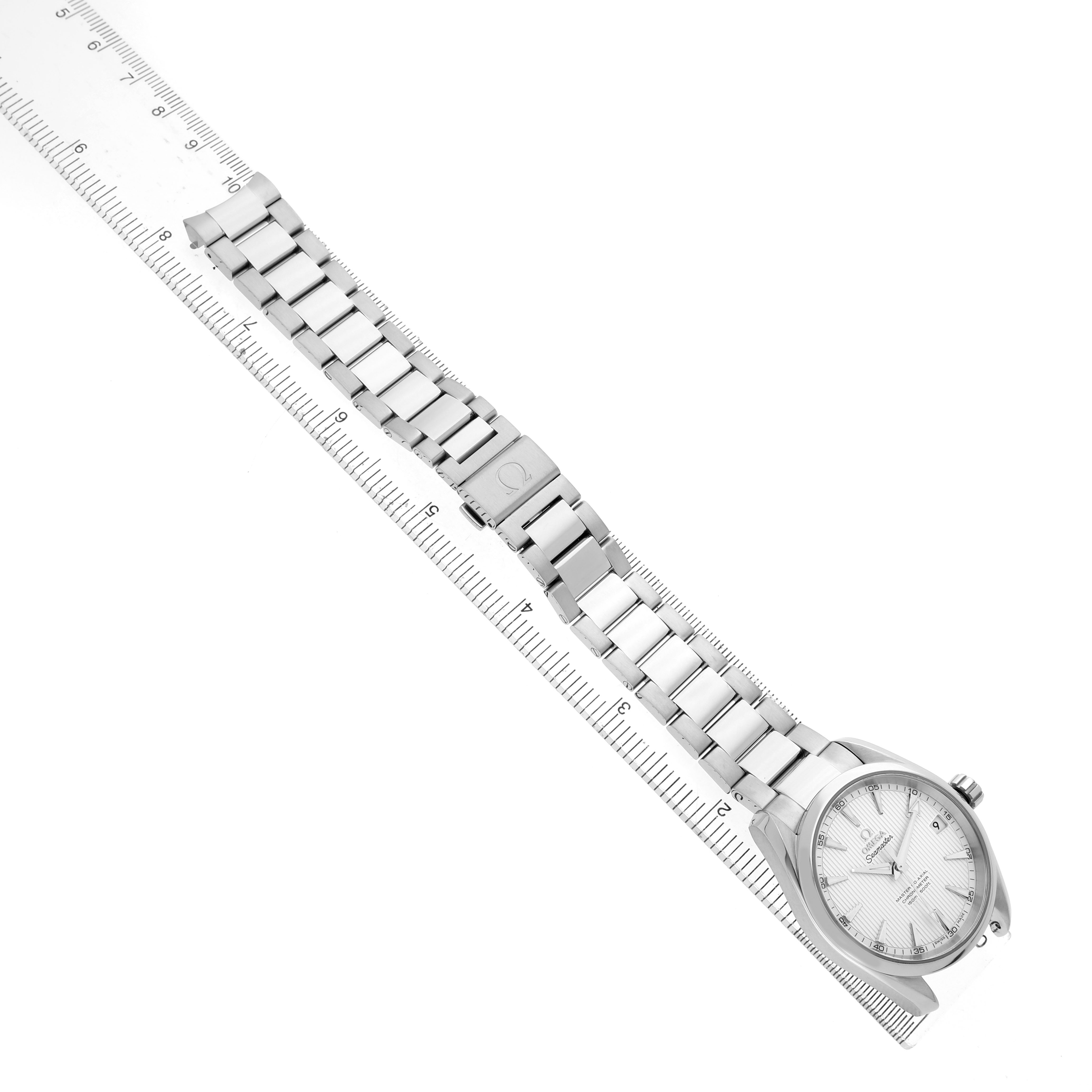 The Omega Seamaster 231.10.39.21.02.002 Men's Stainless Steel Silver Dial watch is angled diagonally, displaying the bracelet, clasp, and face alongside a ruler for scale.