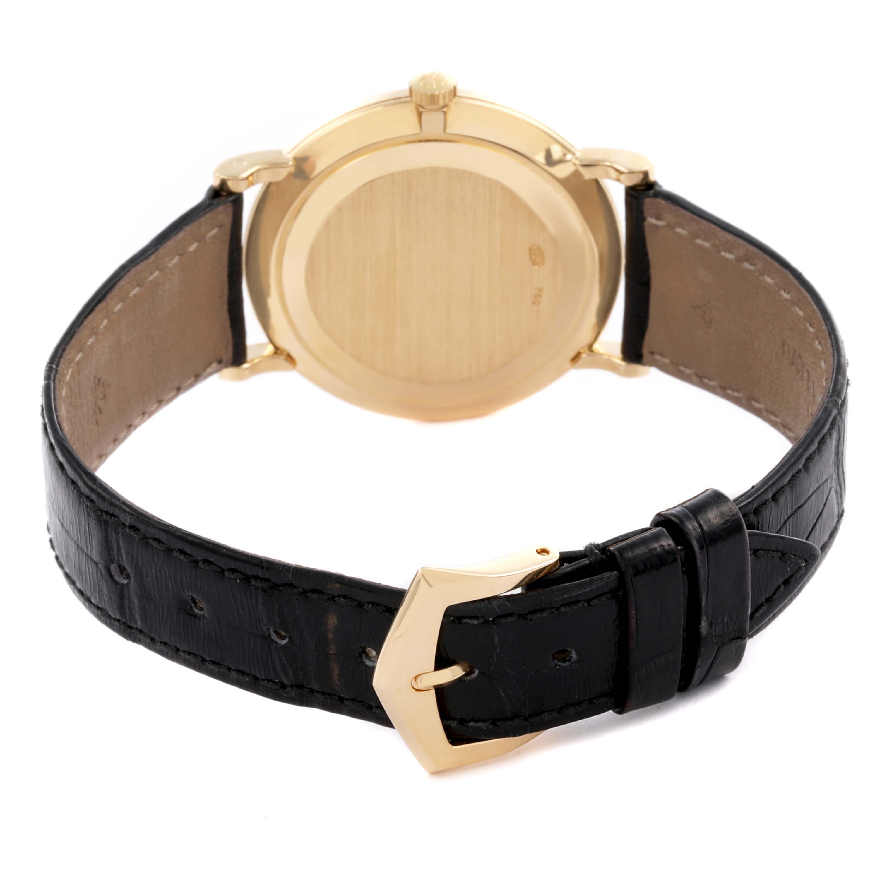 The Patek Philippe Calatrava 5022J Men's Yellow Gold White Dial 5022J Men's Yellow Gold White Dial watch is shown from the back, highlighting the gold case and black leather strap.