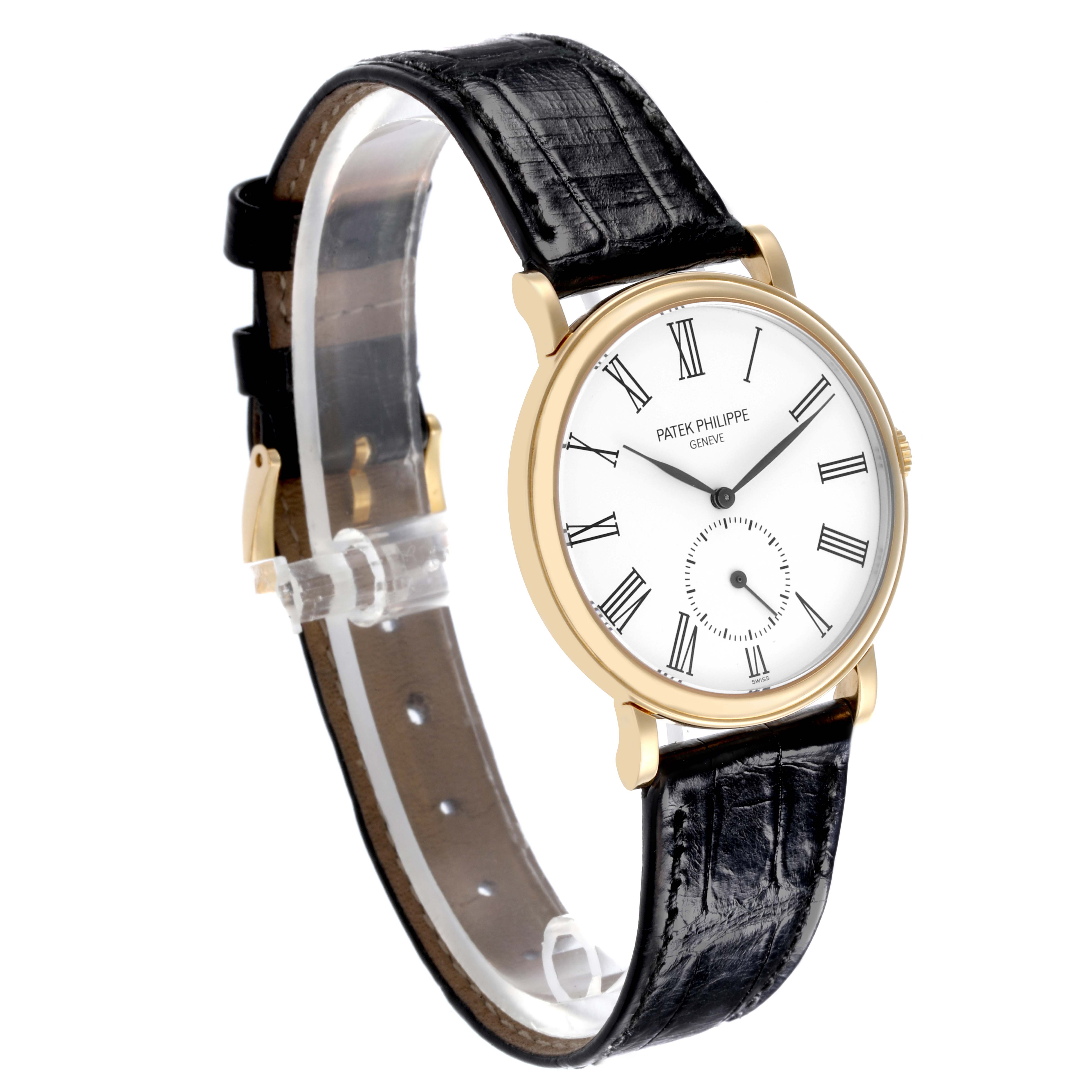 The Patek Philippe Calatrava 5022J Men's Yellow Gold White Dial 5022J Men's Yellow Gold White Dial watch is shown at a three-quarter angle, displaying the face, case, and leather strap.