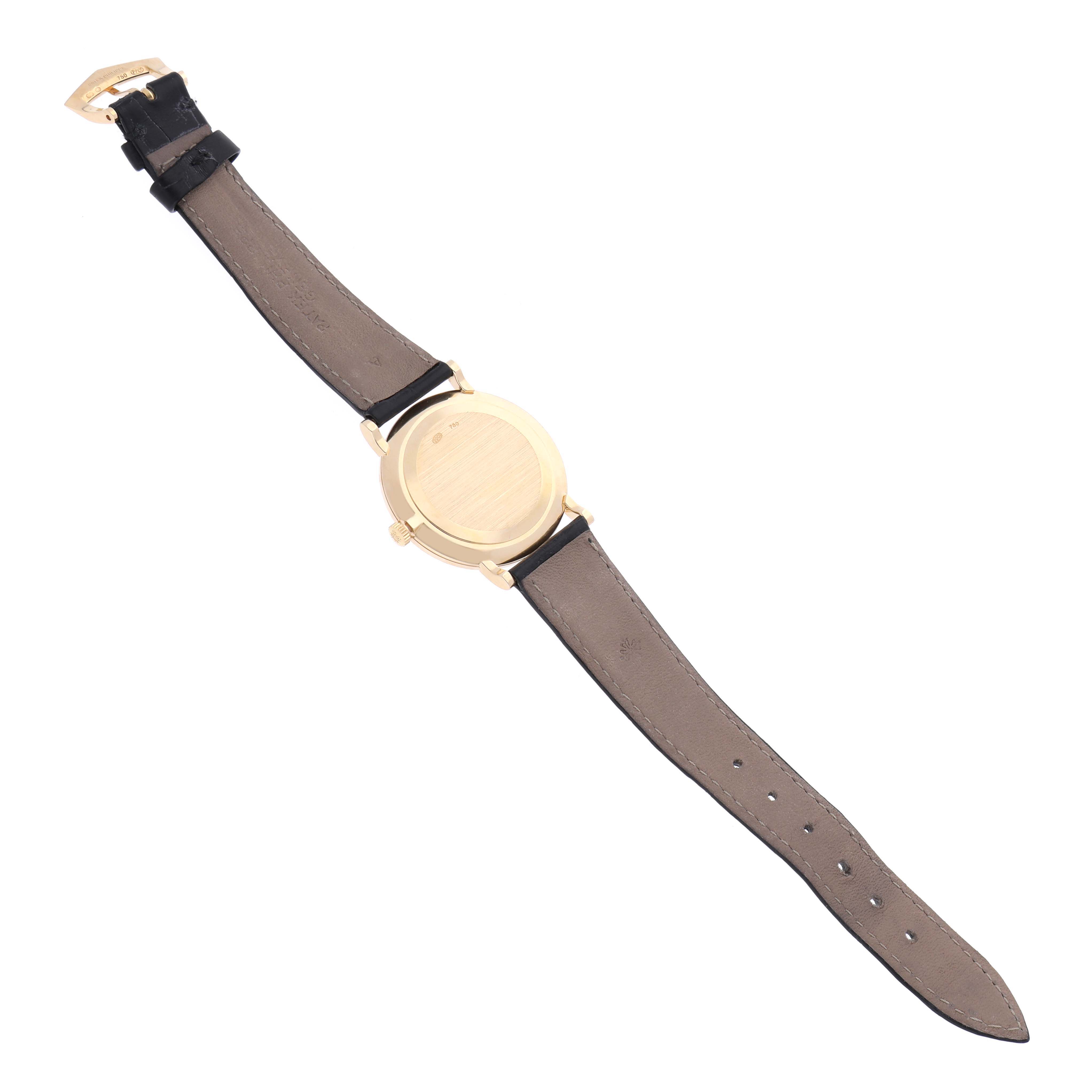 The Patek Philippe Calatrava 5022J Men's Yellow Gold White Dial 5022J Men's Yellow Gold White Dial watch is shown from the back, displaying the case and leather strap.