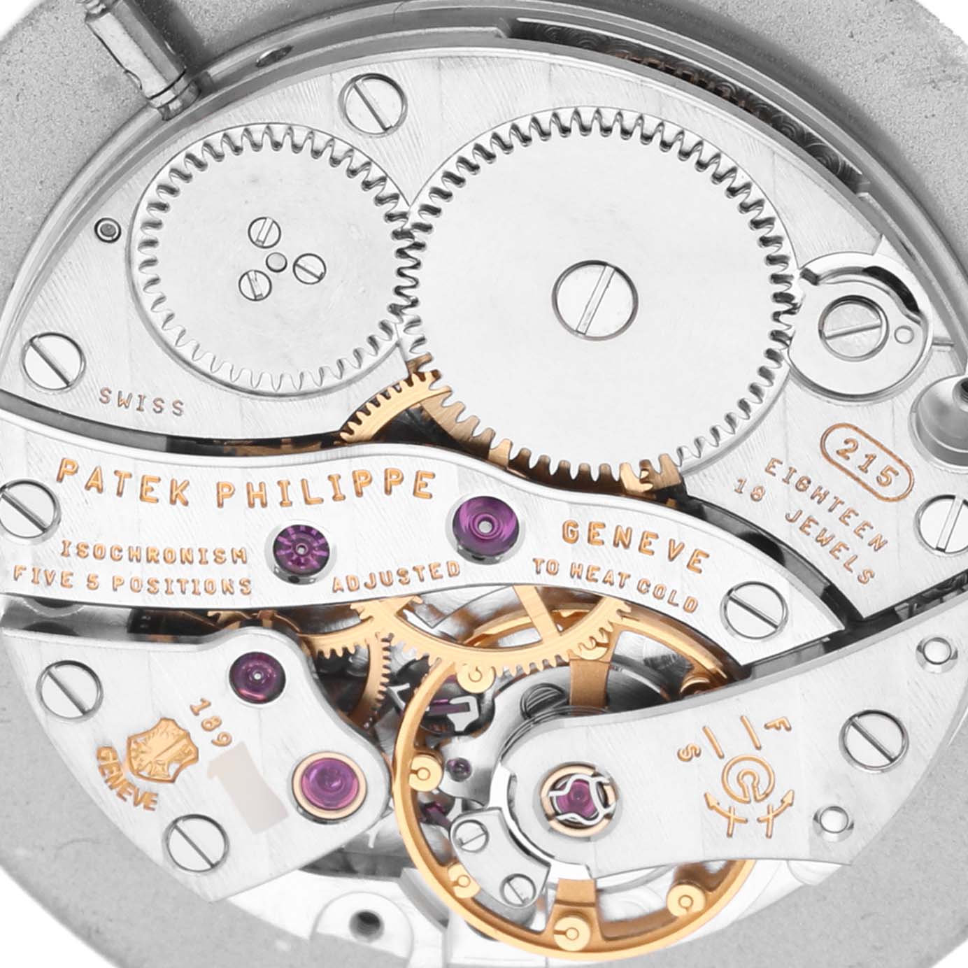 The image shows the intricate movement and gears of a Patek Philippe Calatrava 5022J Men's Yellow Gold White Dial 5022J Men's Yellow Gold White Dial watch from a close-up angle.