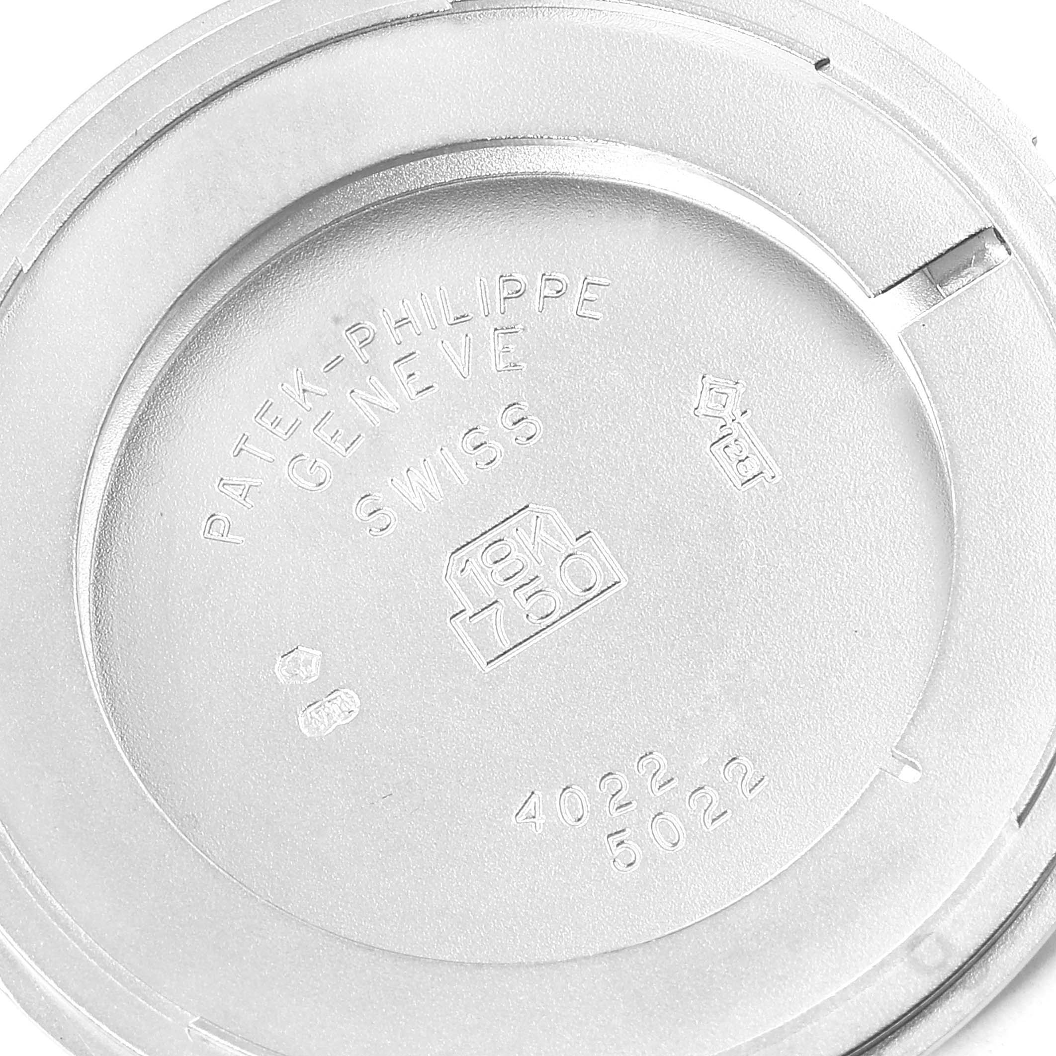 The image shows the inside of the case back of a Patek Philippe Calatrava 5022G Men's White Gold Black Dial 5022G Men's White Gold Black Dial watch, displaying hallmark engravings.