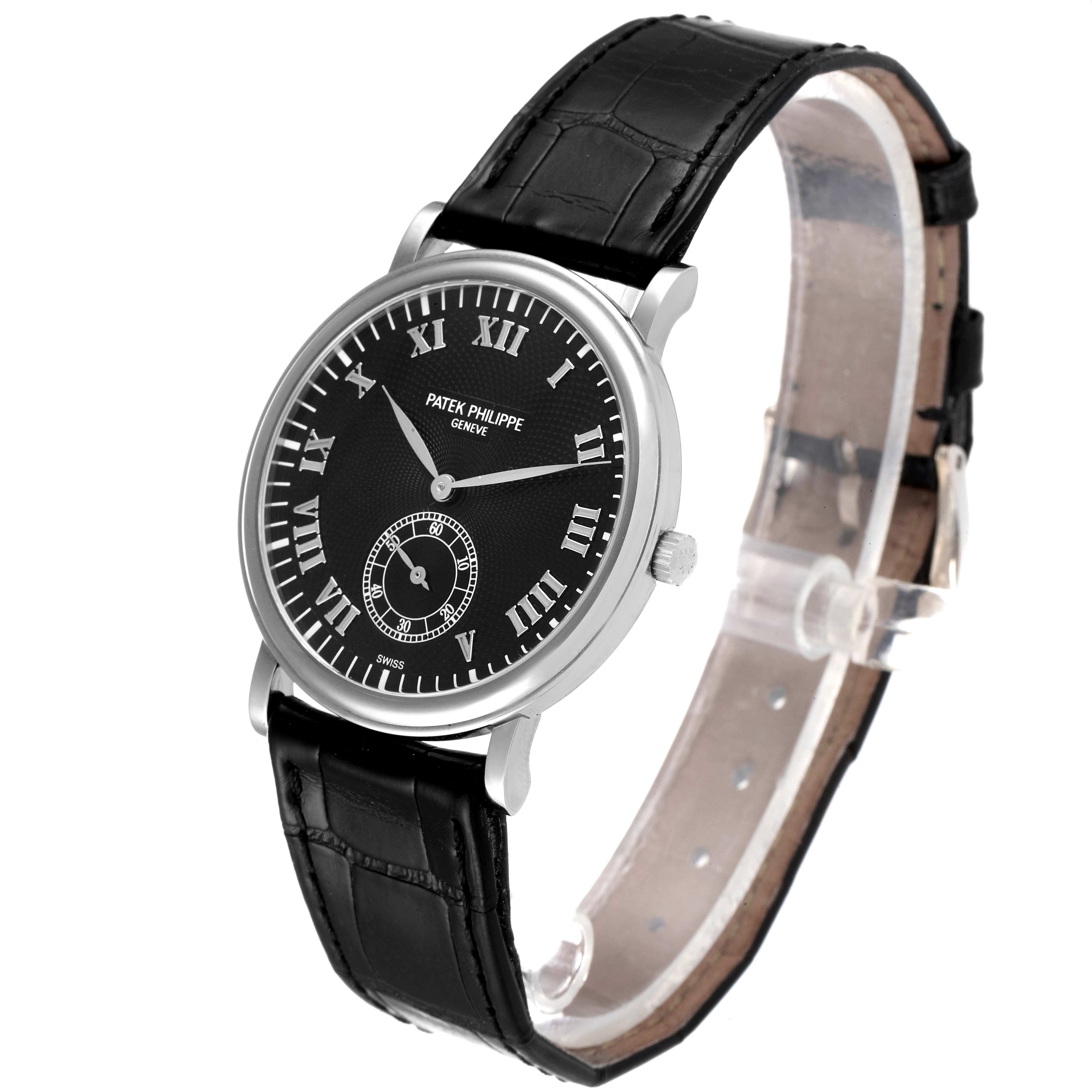 The Patek Philippe Calatrava 5022G Men's White Gold Black Dial 5022G Men's White Gold Black Dial model watch is shown at an oblique angle, detailing its black dial, Roman numerals, and black leather strap.