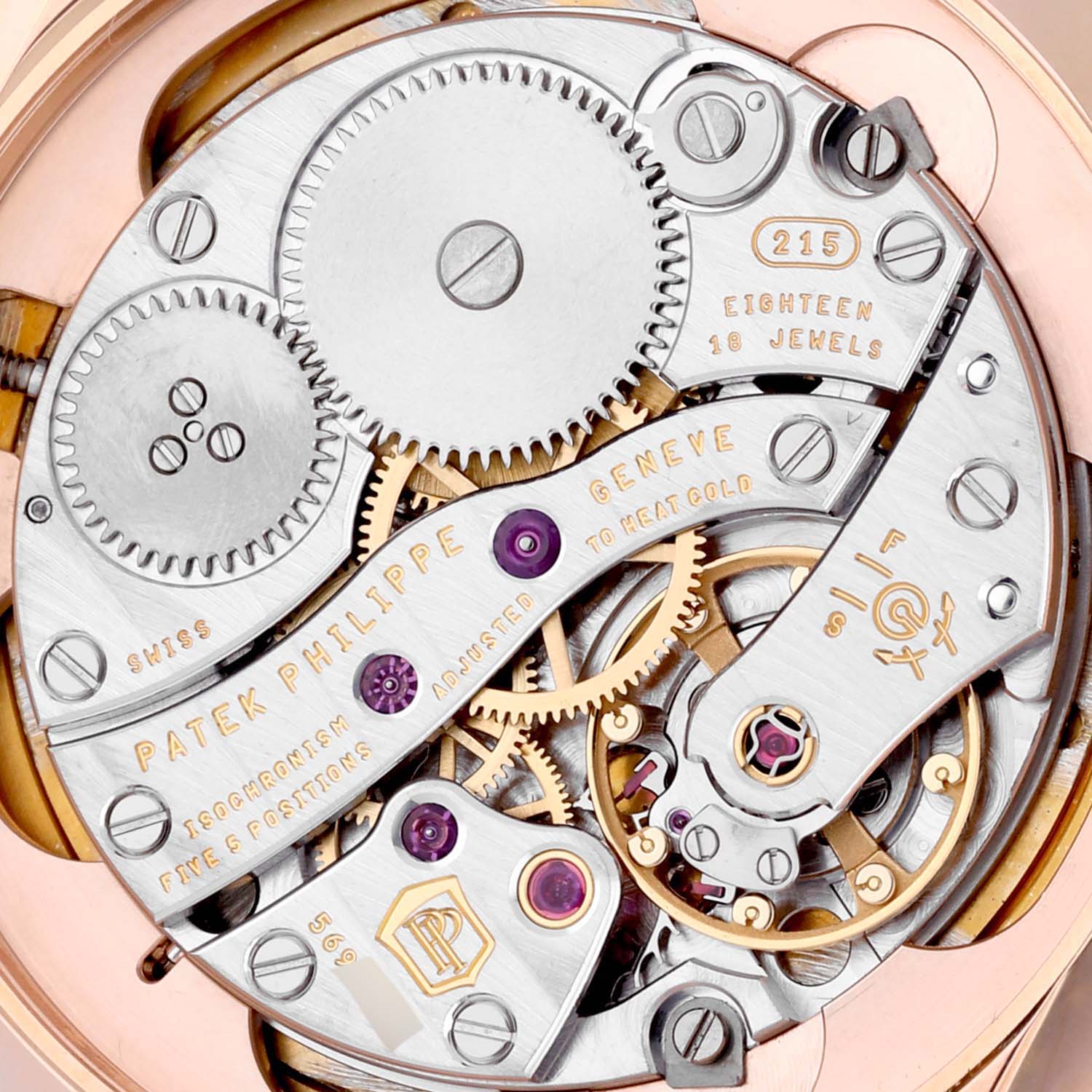 The image shows the intricate movement of a Patek Philippe Calatrava 5123R Men's Rose Gold Silver Dial 5123R Men's Rose Gold Silver Dial watch, highlighting its gears and jewel bearings.