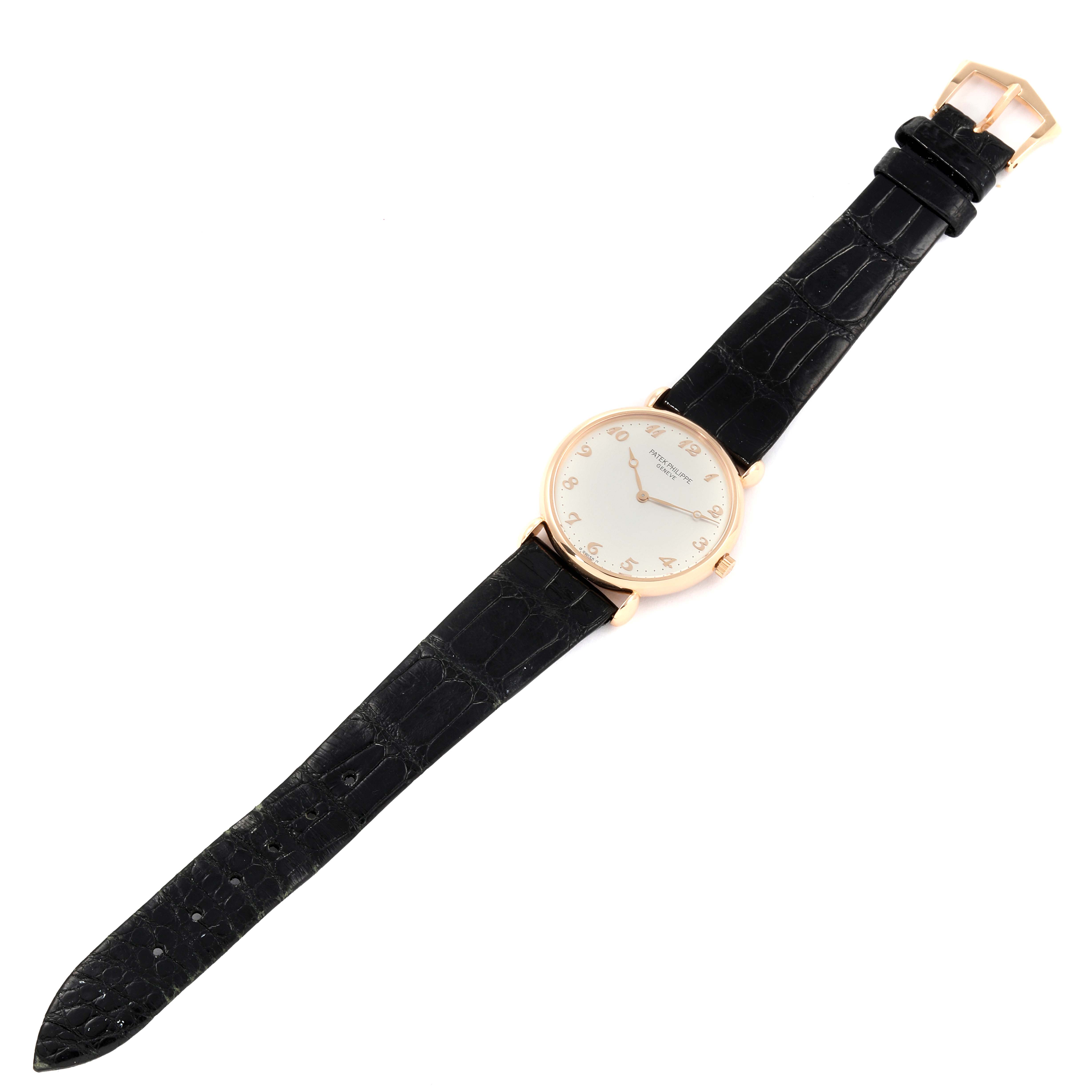 The image shows a top-down view of a Vintage Patek Philippe watch with a black leather strap and a gold case.