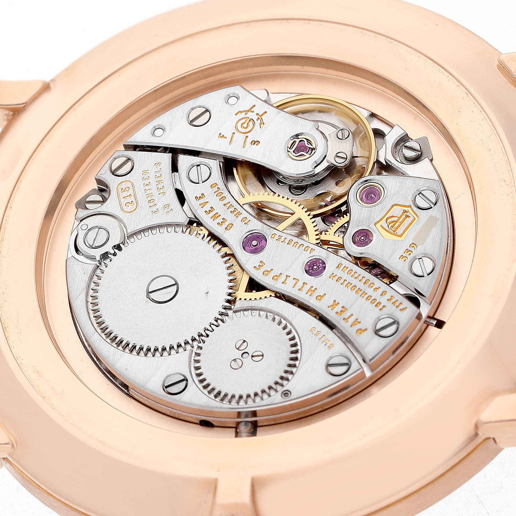 The image shows the movement from the back of a Patek Philippe Calatrava 5119R-001 Men's Rose Gold White Dial, highlighting the intricate gears and inscriptions.