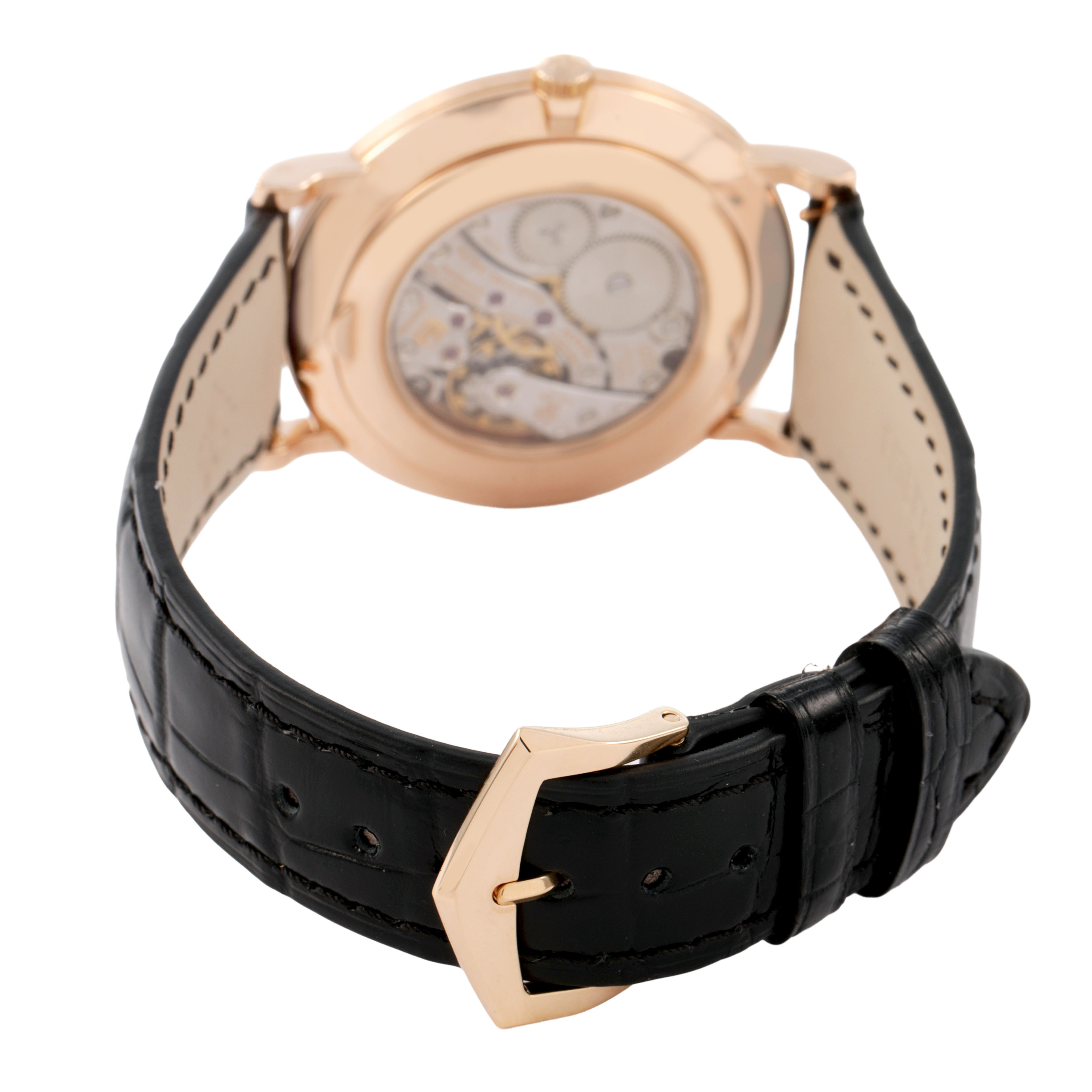 The Patek Philippe Calatrava 5119R-001 Men's Rose Gold White Dial watch is shown from the back, highlighting the transparent case back and black leather strap.