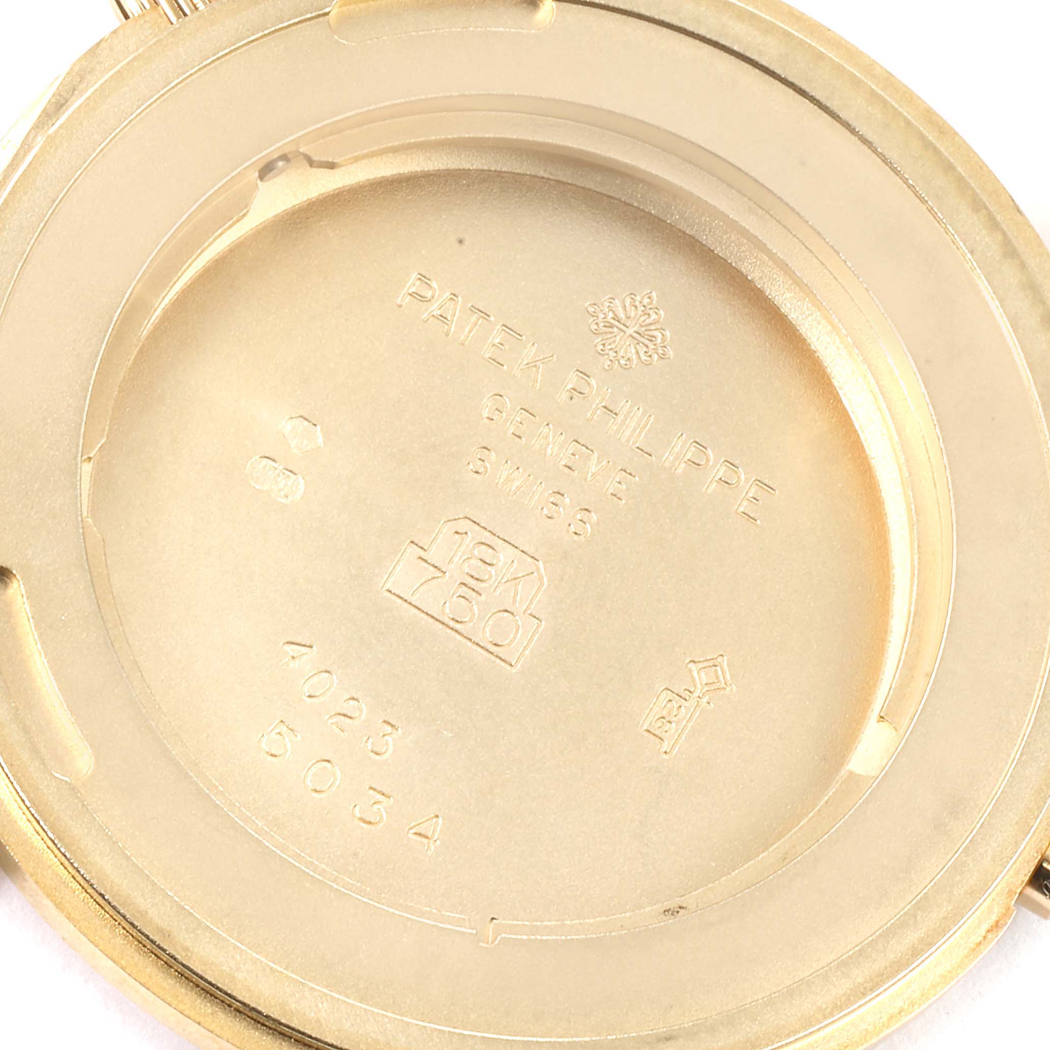 This image shows the inside case back and markings of a Patek Philippe Calatrava 5034J Men's Yellow Gold White Dial 5034J Men's Yellow Gold White Dial watch, displaying model and brand engravings.