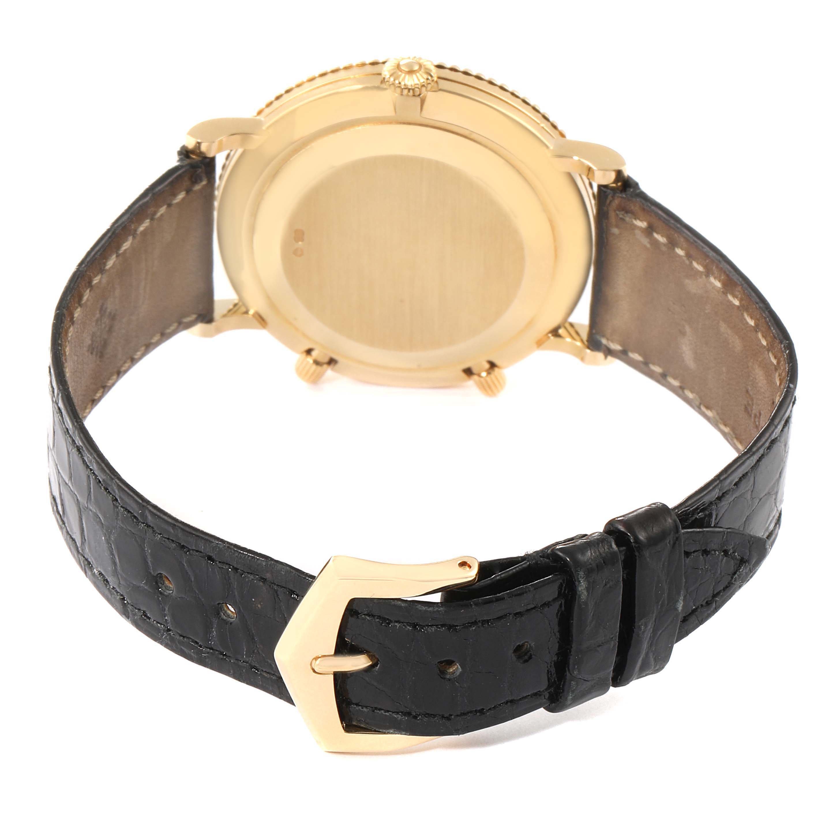 The image shows the back of a Patek Philippe Calatrava 5034J Men's Yellow Gold White Dial 5034J Men's Yellow Gold White Dial watch, highlighting the case, crown, and leather strap with buckle.