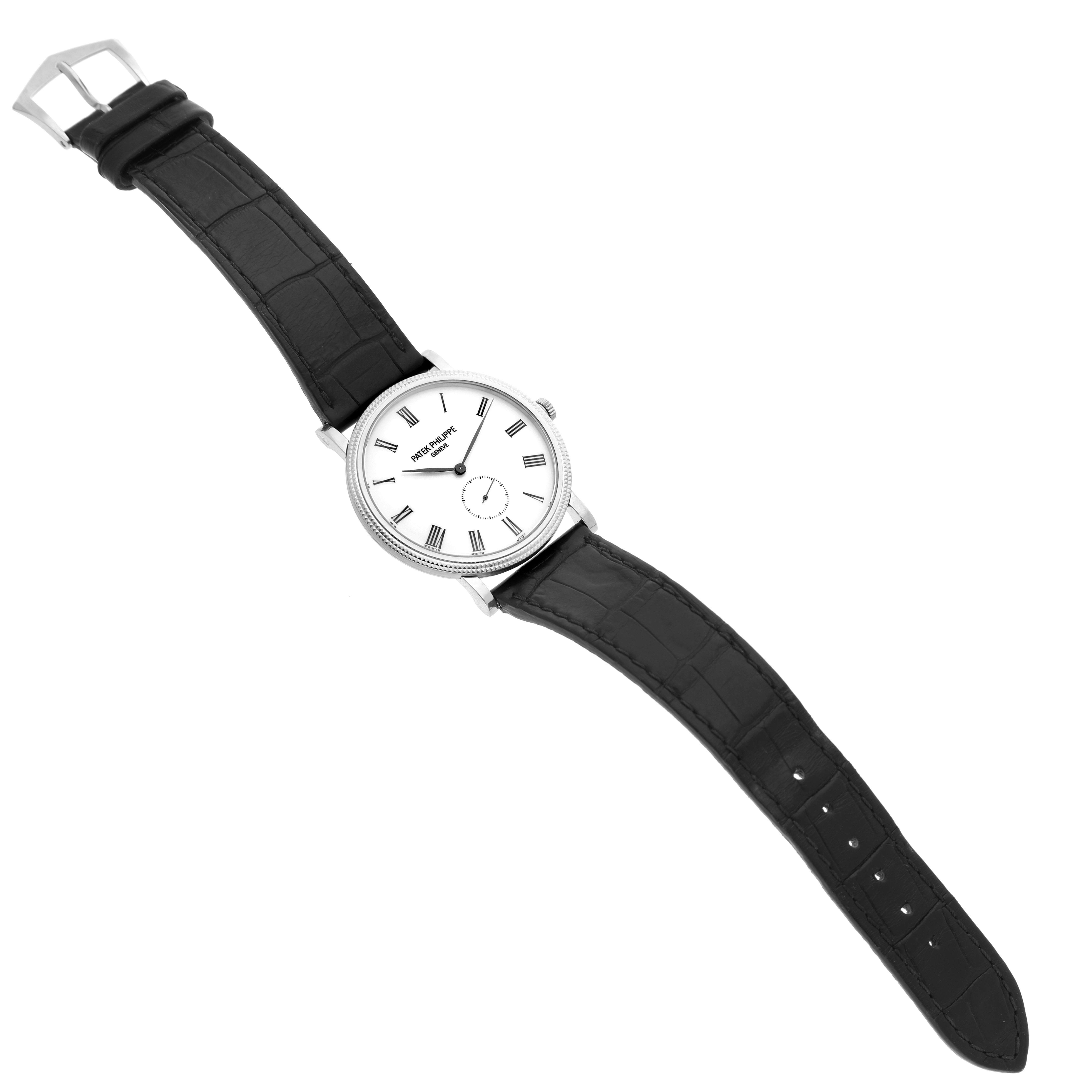 The Patek Philippe Calatrava 5119G-001 Men's White Gold White Dial watch is shown from a top view, displaying the dial, bezel, crown, and leather strap.