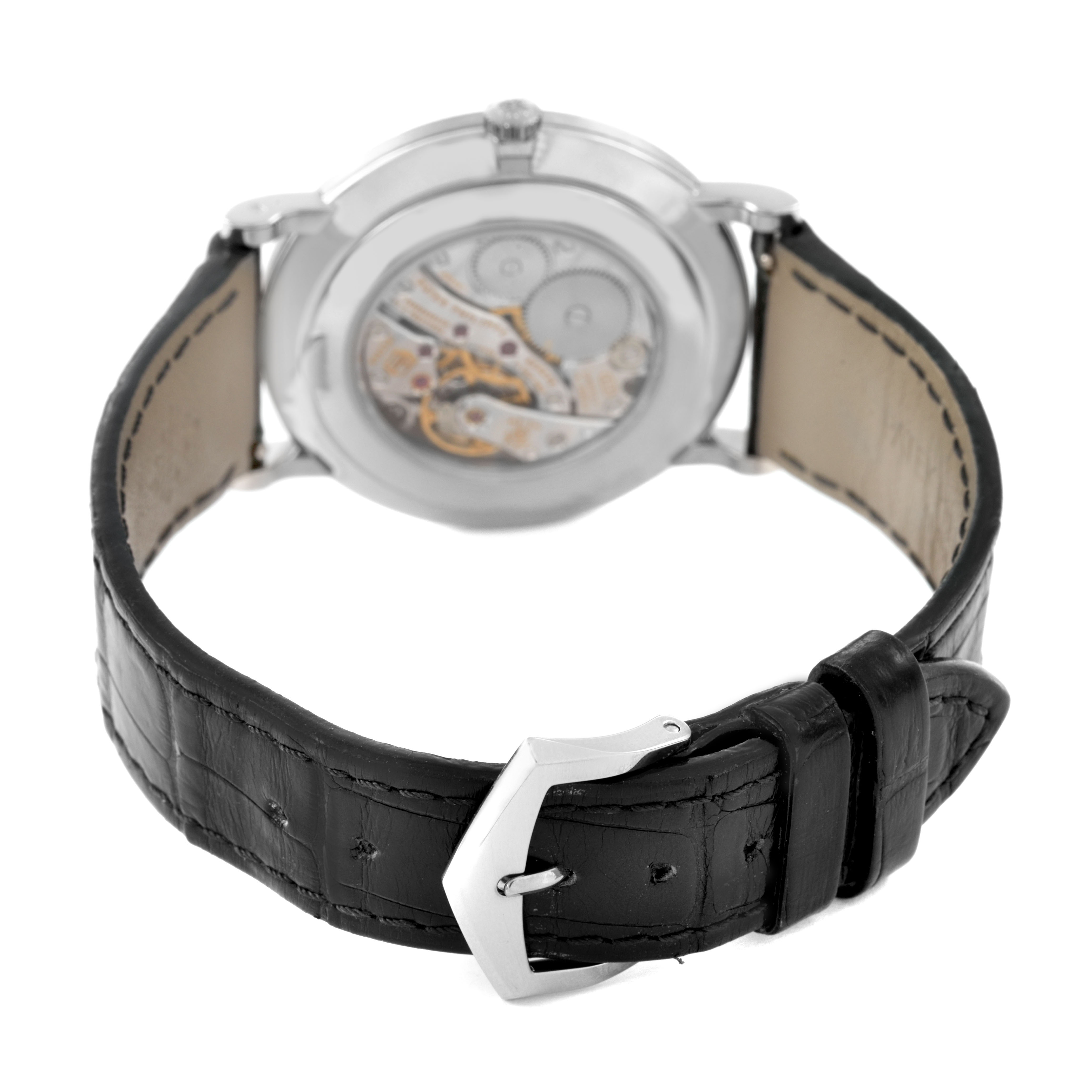 The image shows the back of a Patek Philippe Calatrava 5119G-001 Men's White Gold White Dial watch, highlighting its movement and leather strap with a buckle.