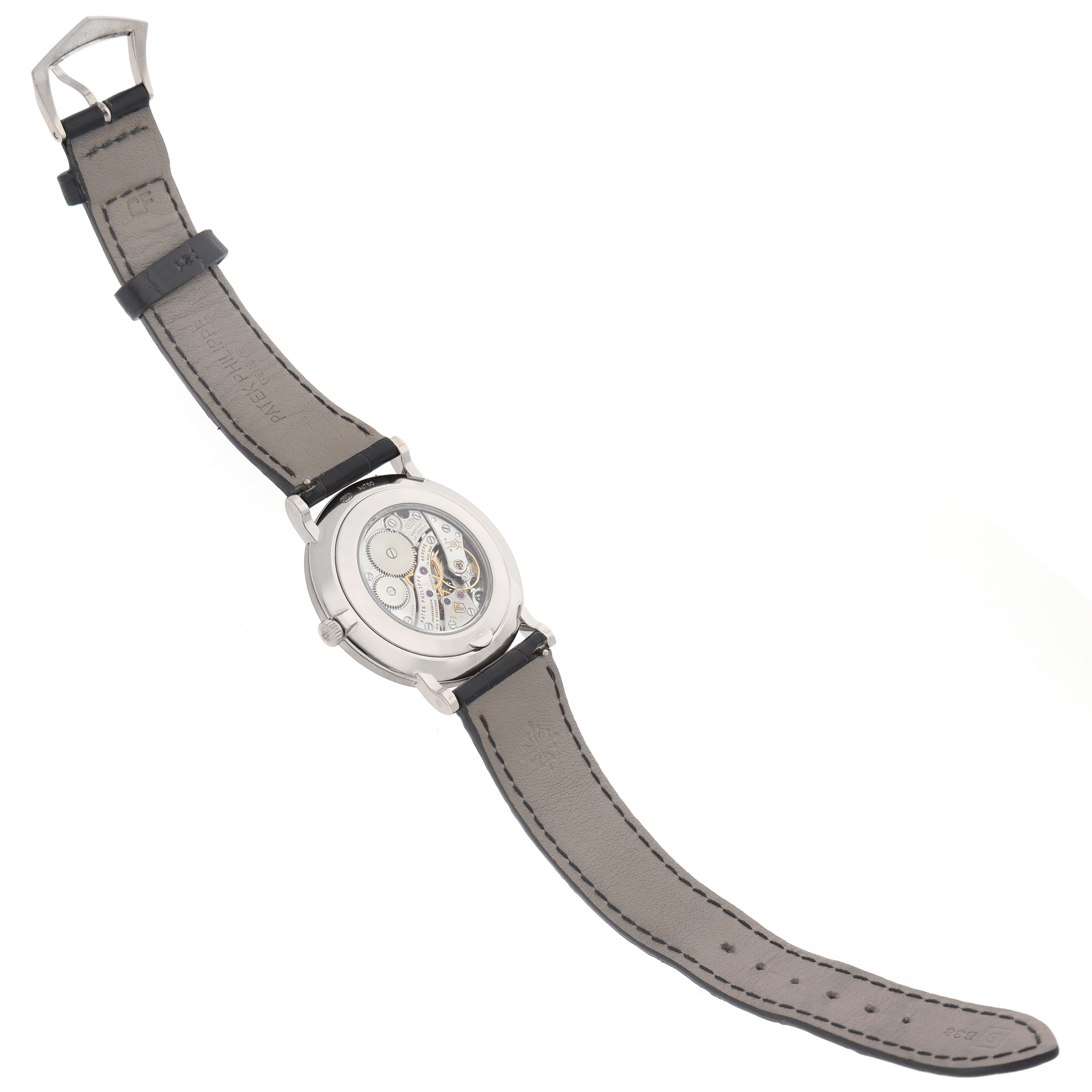 The image shows the back view of a Patek Philippe Calatrava 5119G-001 Men's White Gold White Dial watch, highlighting the movement and leather strap.