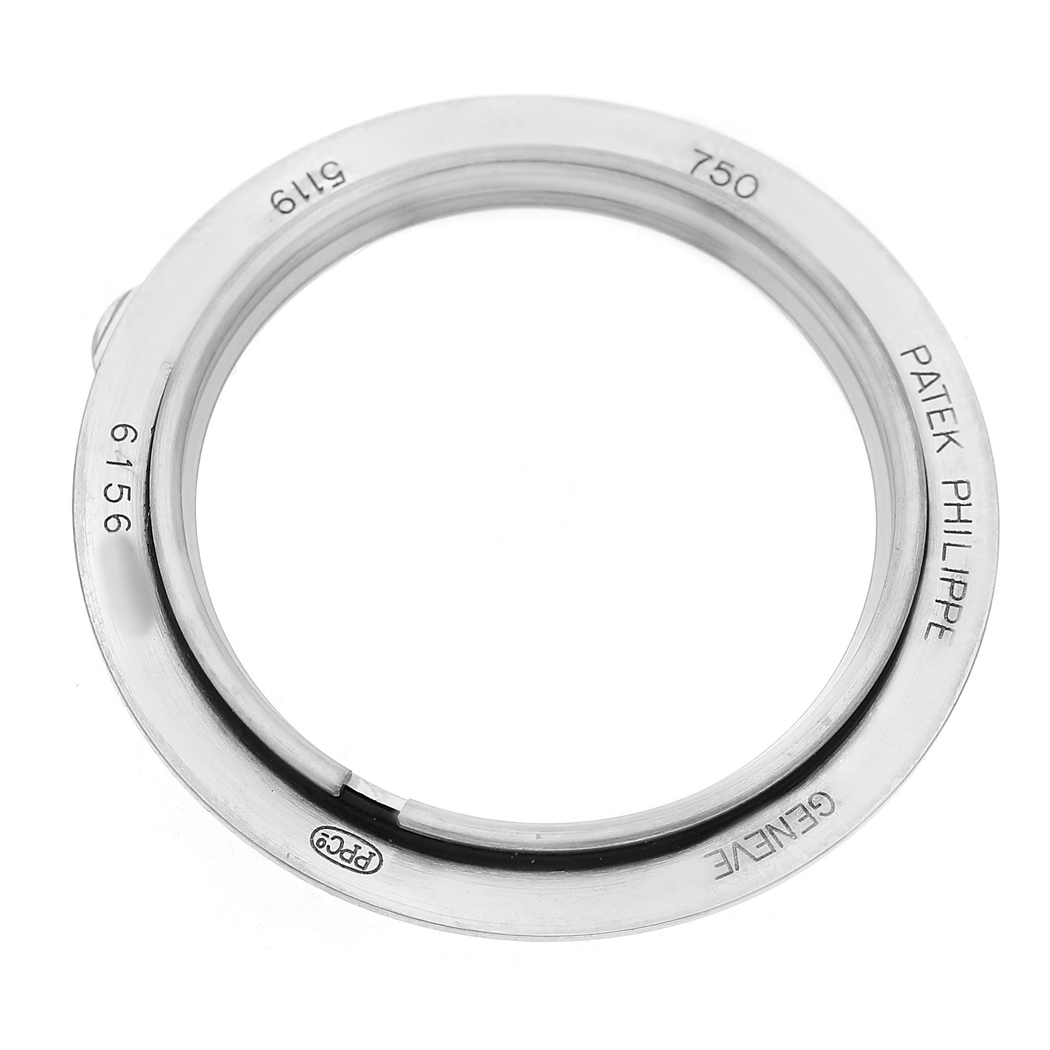 The image shows a close-up of a Patek Philippe Calatrava 5119G-001 Men's White Gold White Dial watch bezel, displaying engraving and hallmark details.