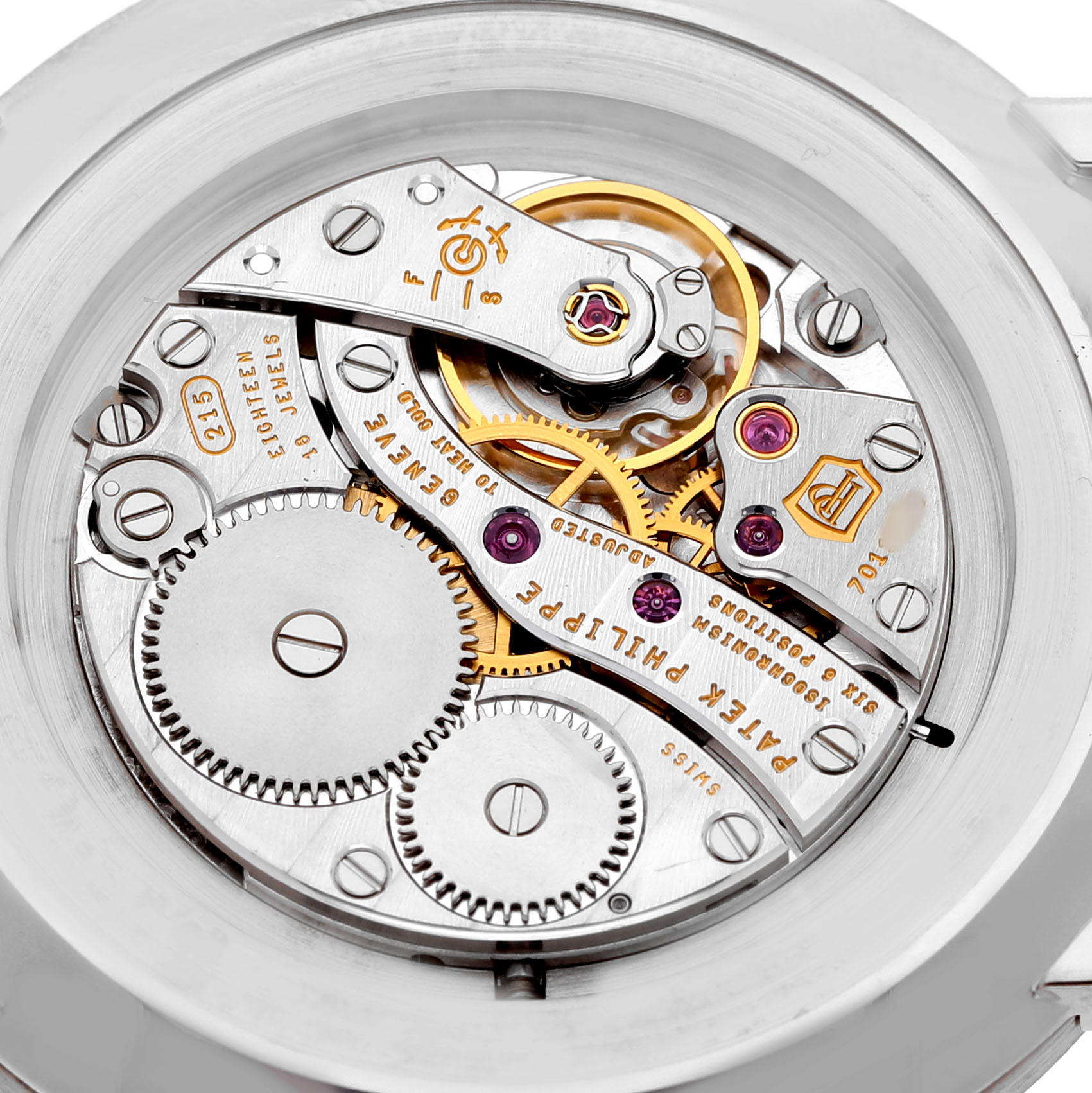 The image shows the intricate inner workings of a Patek Philippe Calatrava 5119G-001 Men's White Gold White Dial watch, highlighting gears and mechanical components from the back.
