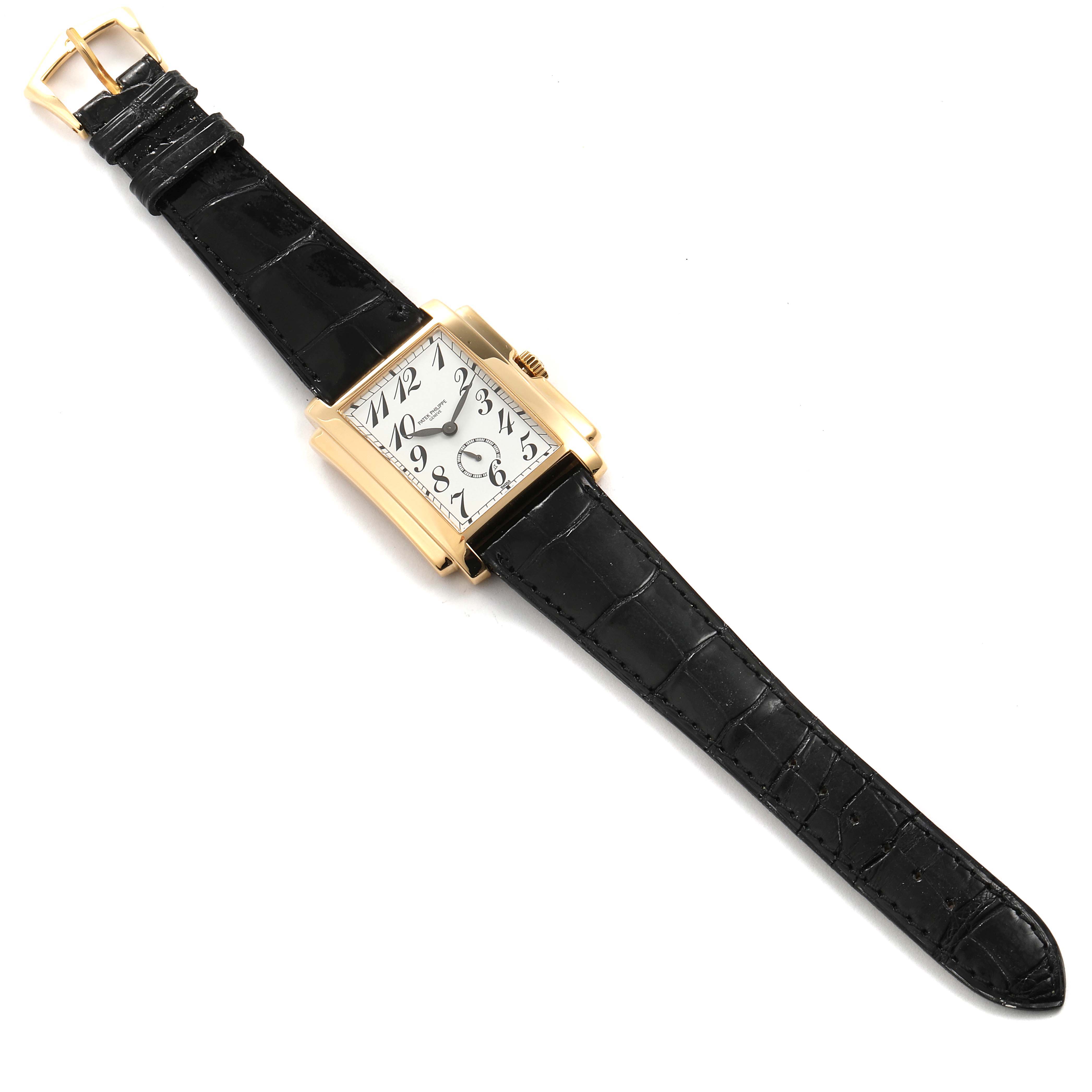 The image shows a Patek Philippe Gondolo 5024J Men
s Yellow Gold Silver Dial 5024J Men
s Yellow Gold Silver Dial watch from a top-down angle, featuring its rectangular dial and black leather strap.