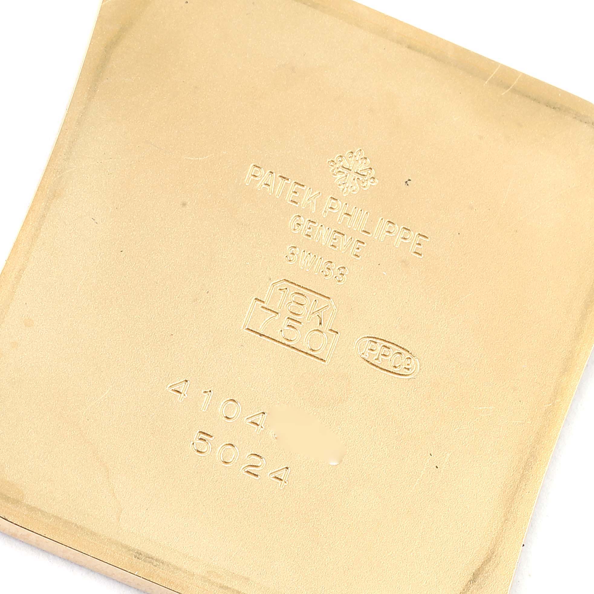 This image shows the back casing of a Patek Philippe Gondolo 5024J Men
s Yellow Gold Silver Dial 5024J Men
s Yellow Gold Silver Dial watch, featuring the brand engravings and gold purity marks.