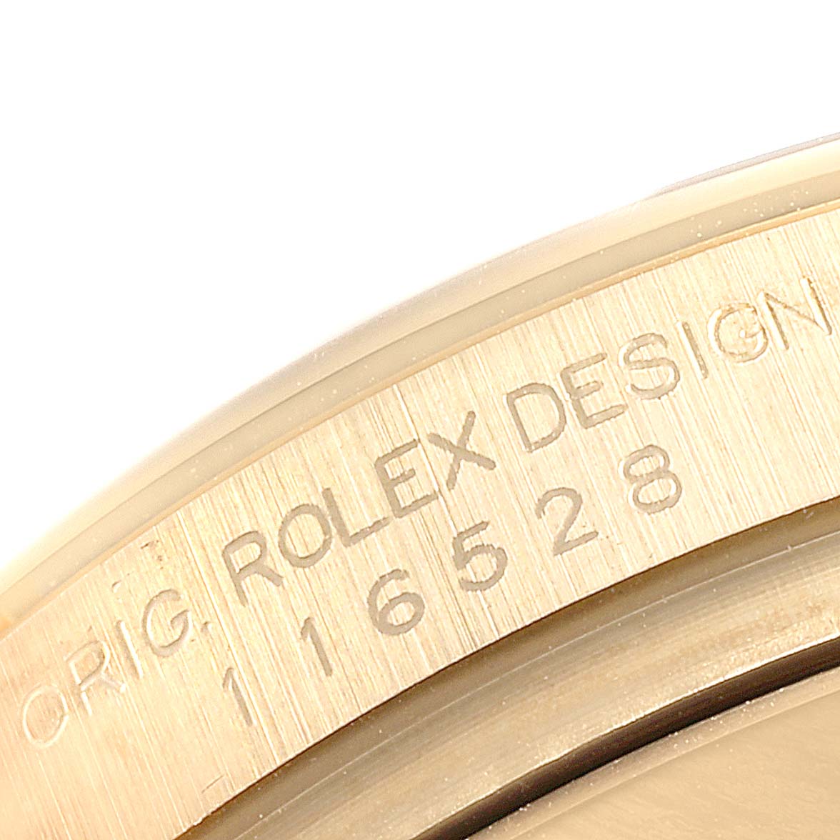 This image shows a close-up of the engraved serial number on the side of a Rolex Daytona 116528 Men's Yellow Gold Black Dial 116528 Men's Yellow Gold Black Dial watch case.