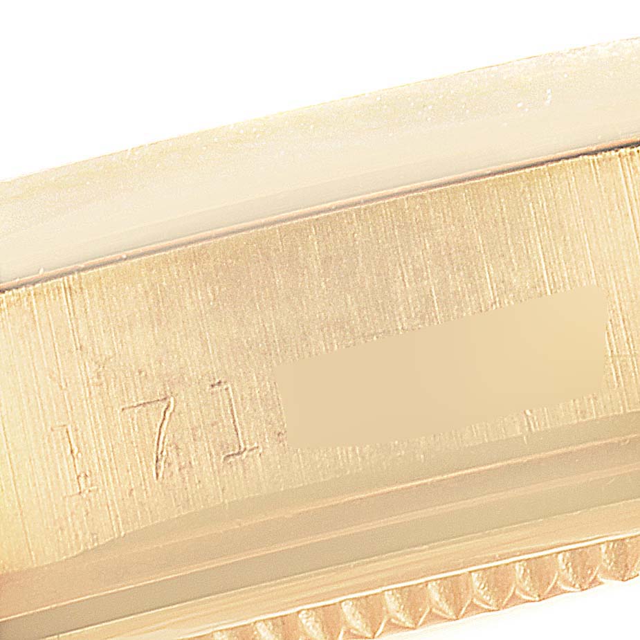 The image shows a close-up of the side of the case of a Rolex Vintage Collection 1500 Men's Yellow Gold Champagne Dial 1500 Men's Yellow Gold Champagne Dial watch, highlighting engraved details.