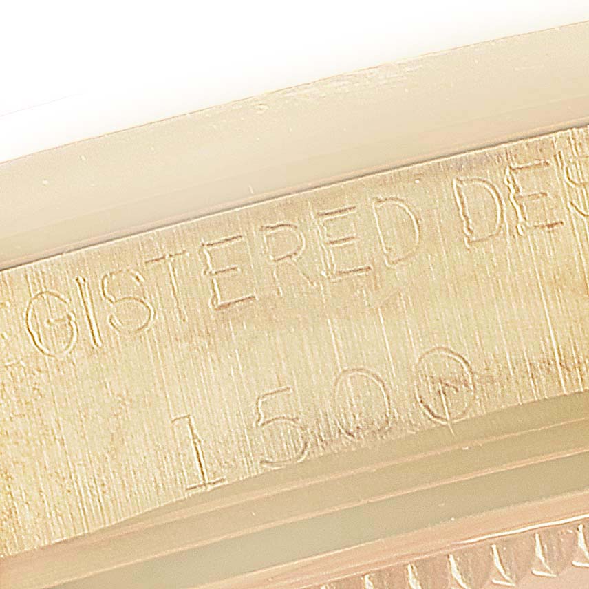 This close-up image shows the engraved text and part of the bezel for the Rolex Vintage Collection 1500 Men's Yellow Gold Champagne Dial 1500 Men's Yellow Gold Champagne Dial model.