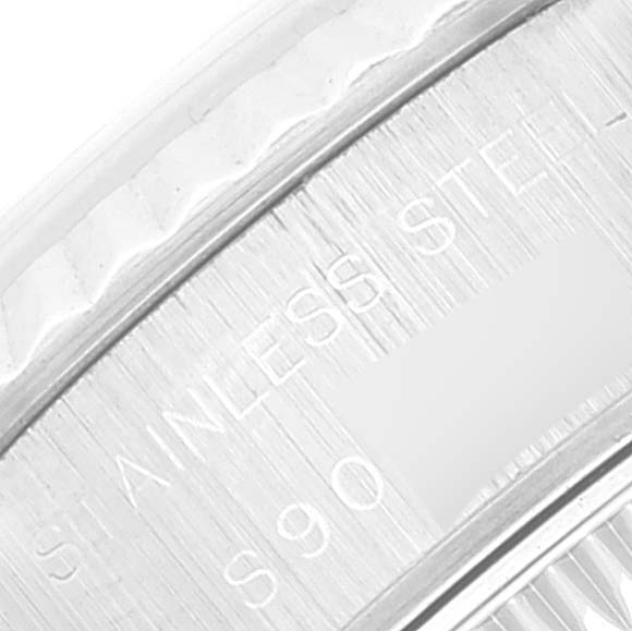 The image shows the side engraving on a stainless steel Rolex Datejust 69174 Women's Stainless Steel Pink Dial 69174 Women's Stainless Steel Pink Dial watch, featuring part of the bezel and case.