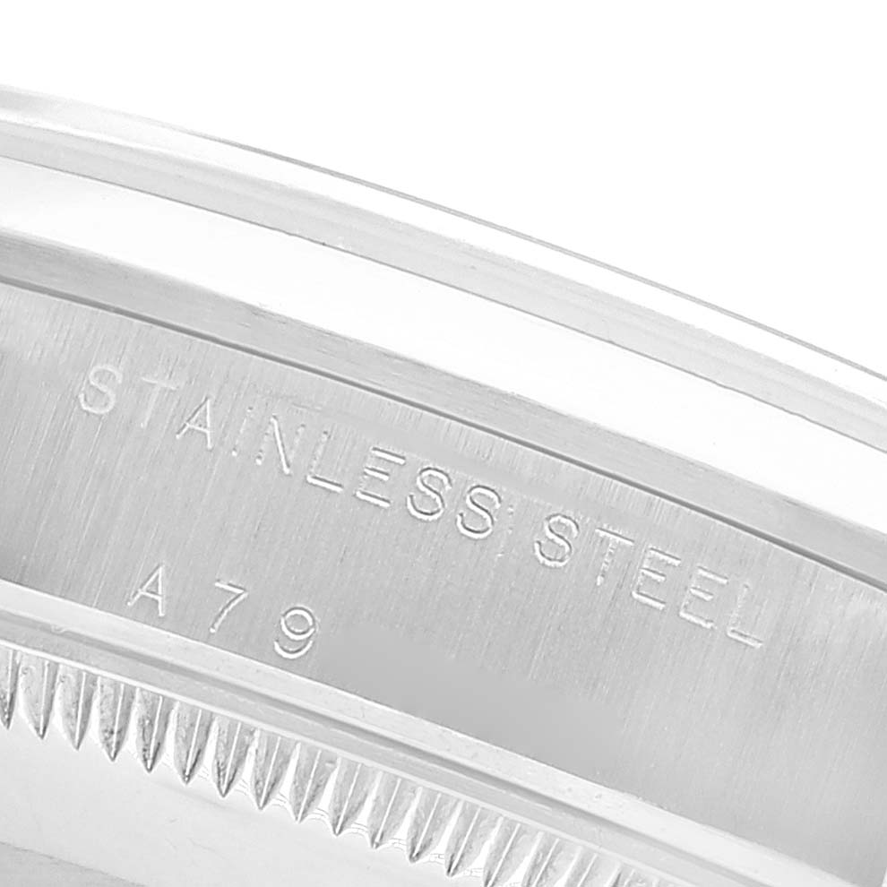 This image shows a close-up of the rim and engravings on the mid-size Rolex watch case, indicating it
s made of stainless steel.