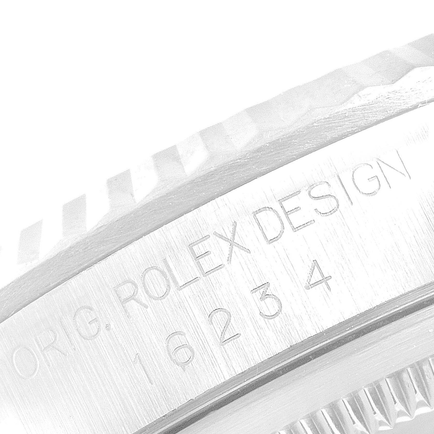 This image shows a close-up of the side engraving and fluted bezel of a Rolex Datejust 16234 Men's Stainless Steel White Dial 16234 Men's Stainless Steel White Dial.