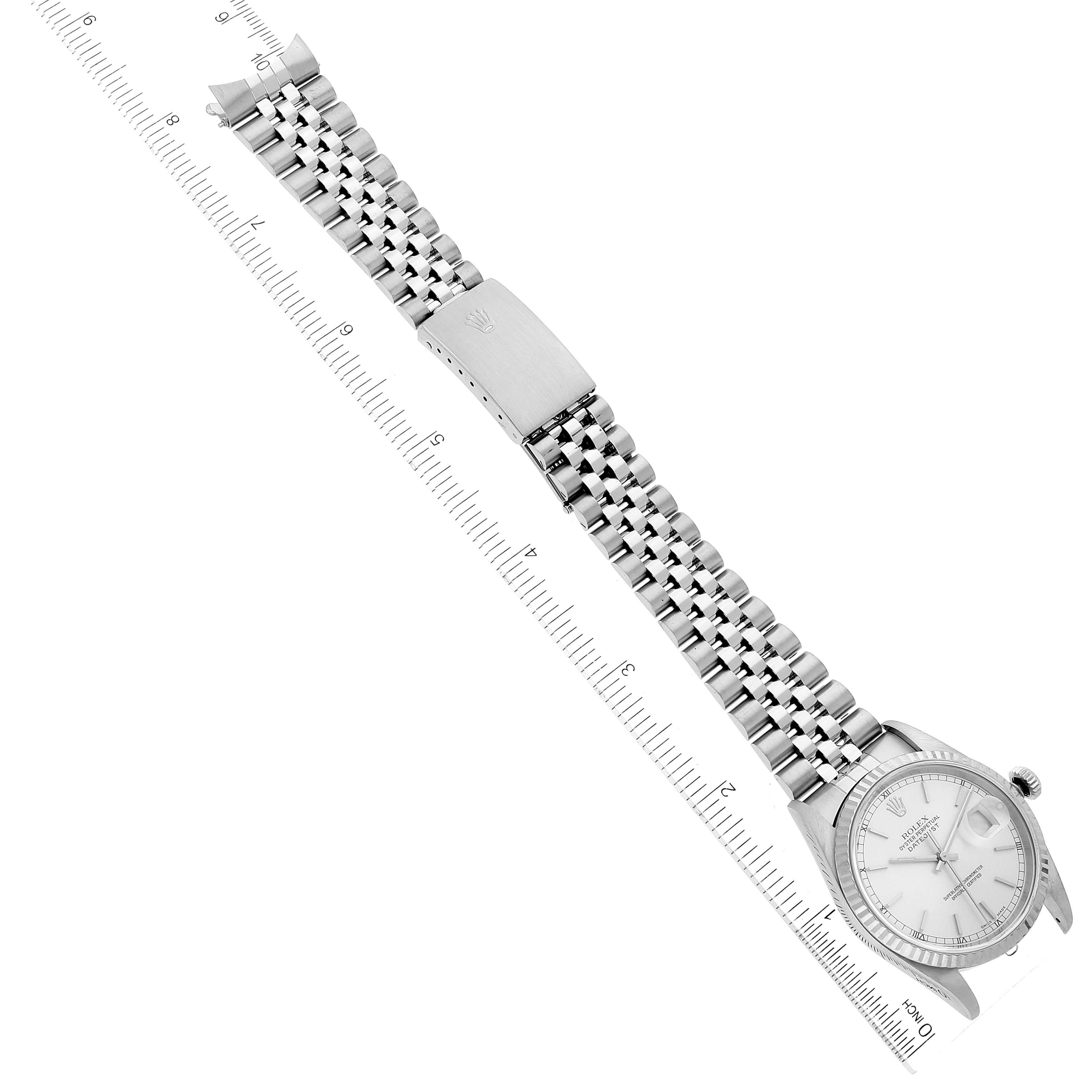 The image shows a Rolex Datejust 16234 Men's Stainless Steel Silver Dial 16234 Men's Stainless Steel Silver Dial watch with its bracelet fully extended, lying diagonally against a ruler.