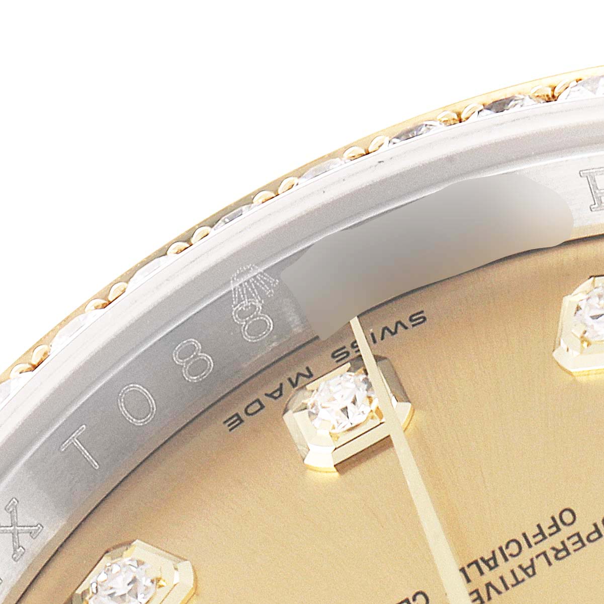 This image shows a close-up of the bezel and dial of a Rolex Datejust 116243 Men's Steel and Gold (two tone) Champagne Dial 116243 Men's Steel and Gold (two tone) Champagne Dial watch, highlighting the diamond hour markers.