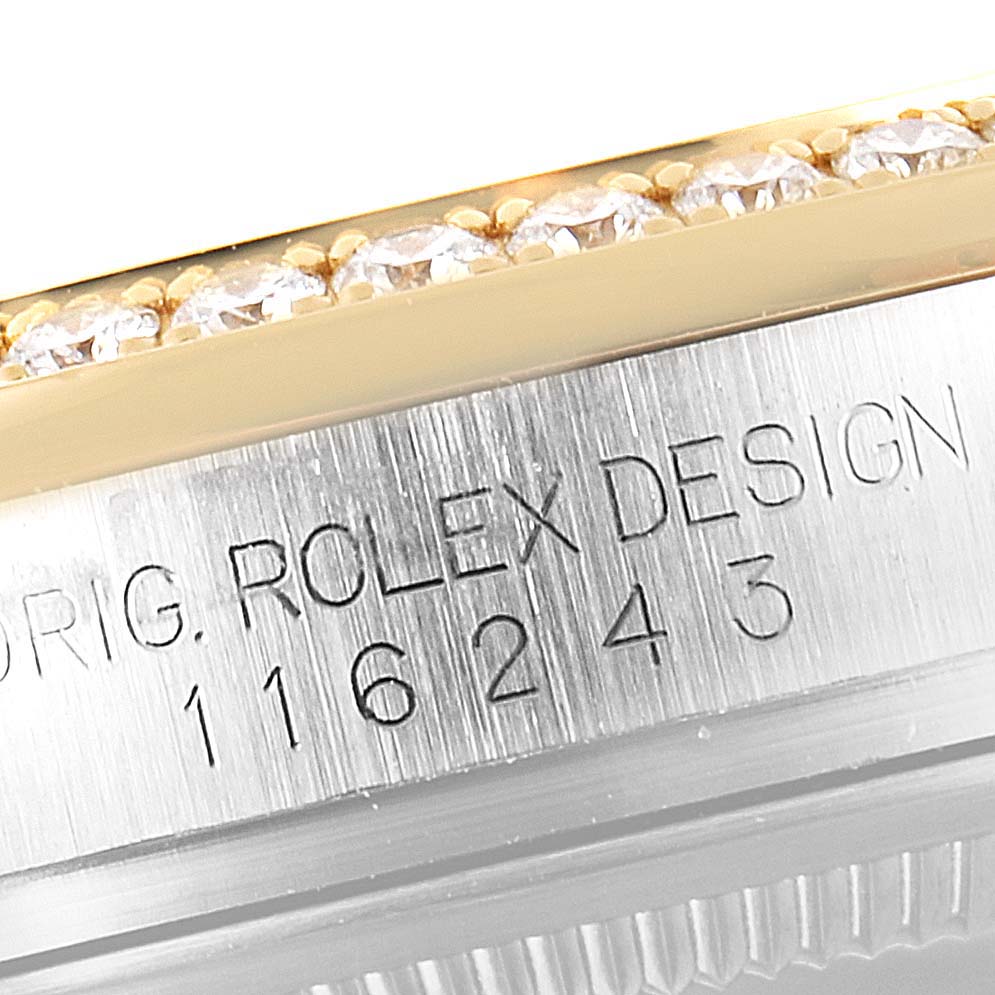 This close-up shows the engraved case side and diamond-set bezel of the Rolex Datejust 116243 Men's Steel and Gold (two tone) Champagne Dial 116243 Men's Steel and Gold (two tone) Champagne Dial watch.