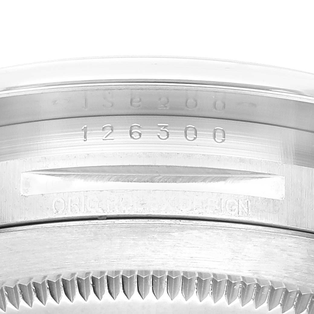 This image shows a close-up of the bezel and serial number engraving on a Rolex Datejust 41 126300 Men
s Stainless Steel Black Dial 126300 Men
s Stainless Steel Black Dial model watch.