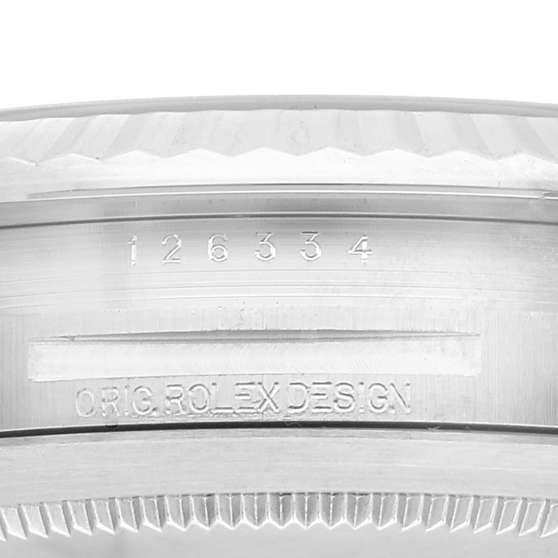The image shows a close-up of the case side of a Rolex Datejust 41 126334 Men's Stainless Steel Blue Dial 126334 Men's Stainless Steel Blue Dial watch, featuring the serial number and "ORIG. ROLEX DESIGN" engraving.