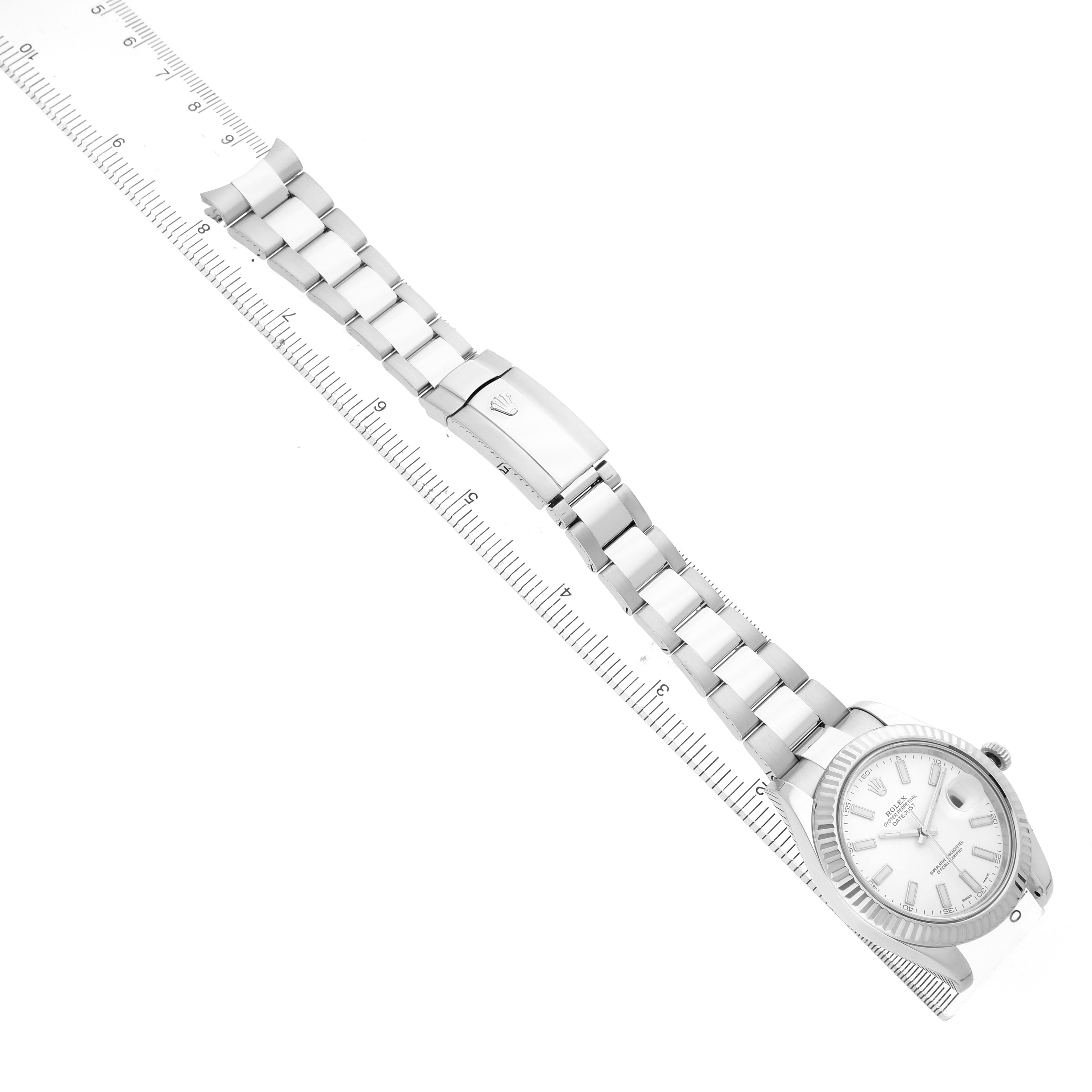 The Rolex Datejust 41 116334 Men's Stainless Steel White Dial watch is shown from the top view, displaying the dial, bracelet, and clasp alongside a ruler for scale.