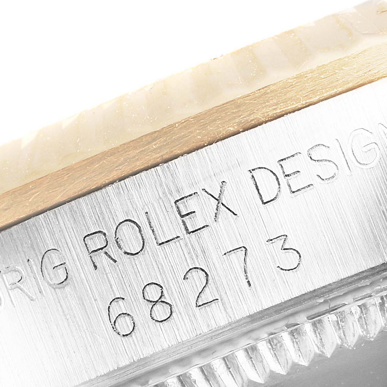 The image shows a close-up angle of the model number and text engraved on the bezel of a Rolex Mid-Size 68273 Women's Steel and Gold (two tone) Champagne Dial 68273 Women's Steel and Gold (two tone) Champagne Dial watch.