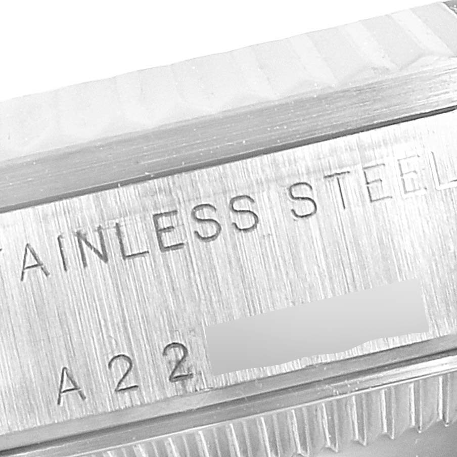 This image shows a close-up of the stainless steel case back of a mid-size Rolex watch.