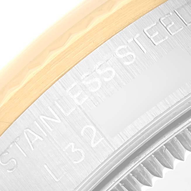 The image shows a close-up of the edge and bezel with "Stainless Steel" engraved on a Mid-Size Rolex watch.