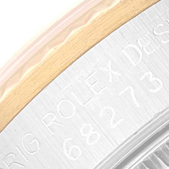 The image shows a macro close-up of the edge and marking on a Rolex Mid-Size 68273 Women
s Steel and Gold (two tone) Silver Dial 68273 Women
s Steel and Gold (two tone) Silver Dial watch.