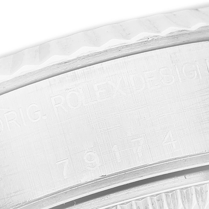 The image shows a close-up of the side engraving on a Rolex Datejust 79174 Women's Stainless Steel Mother of Pearl Dial watch, highlighting the serial number and design markings.