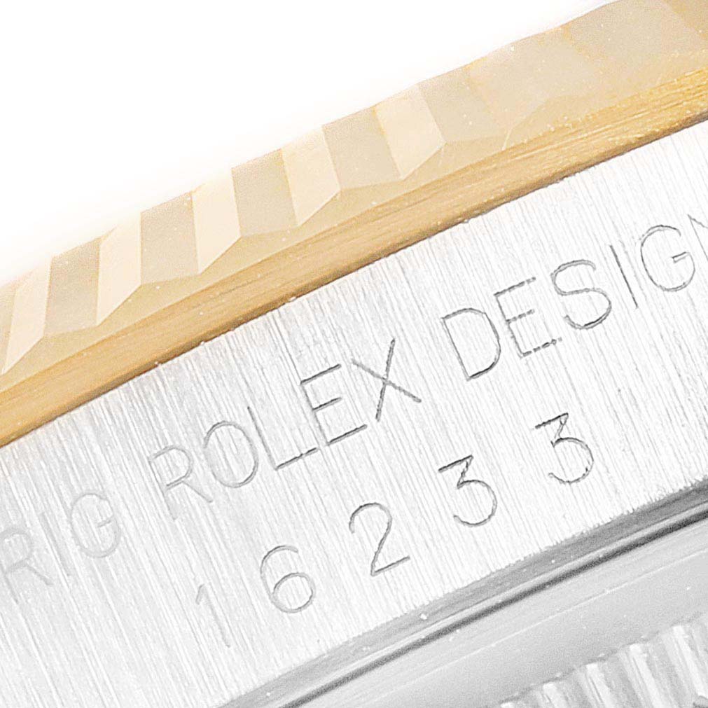 The image shows a close-up of the engraved case side and part of the fluted bezel of a Rolex Datejust 16233 Men's Stainless Steel Champagne Dial 16233 Men's Stainless Steel Champagne Dial watch.