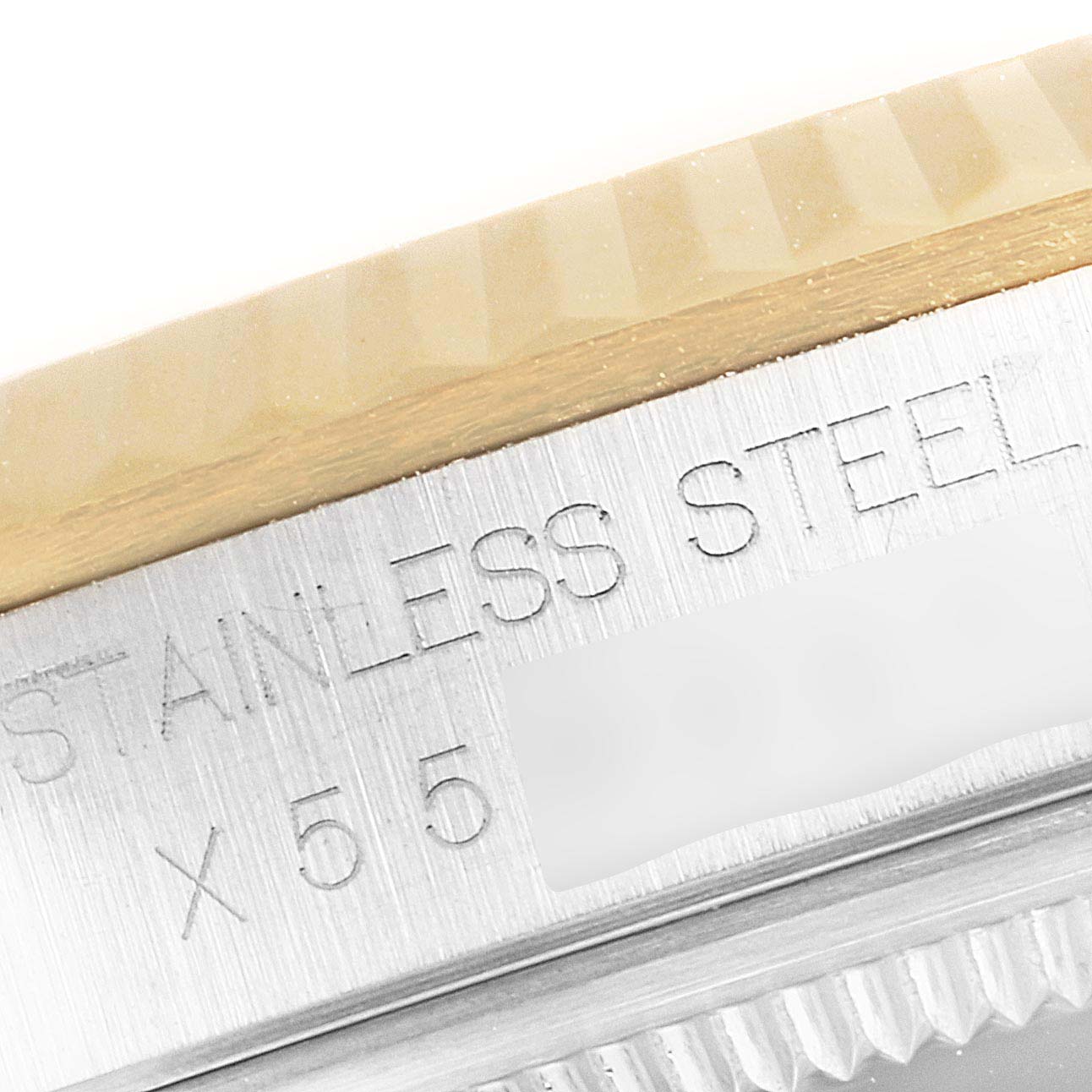 The image shows a close-up of the Rolex Datejust 16233G Men's Steel and Gold (two tone) Silver Dial 16233G Men's Steel and Gold (two tone) Silver Dial's bezel and the engraved information on its stainless steel case.