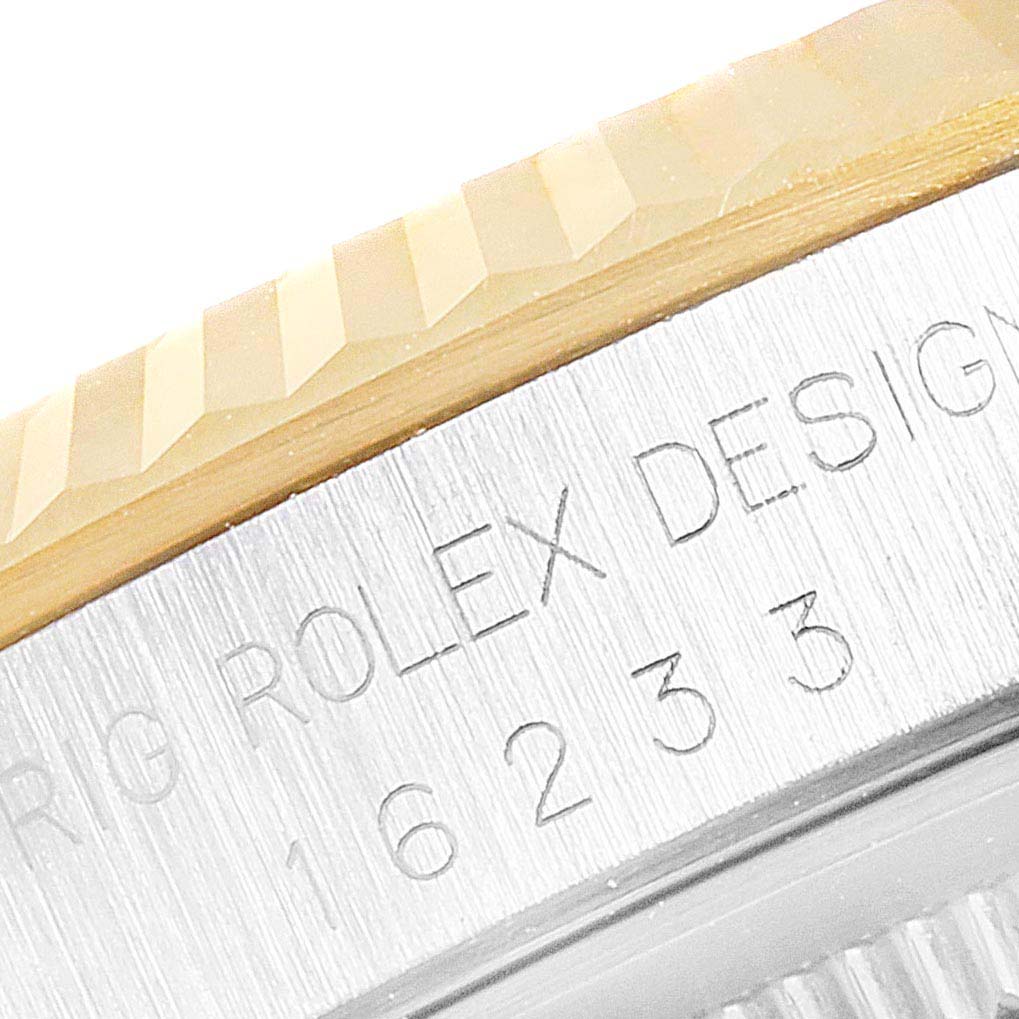 The image shows a close-up of the fluted bezel and the engraved model number on the side case of a Rolex Datejust 16233 Men's Steel and Gold (two tone) Champagne Dial 16233 Men's Steel and Gold (two tone) Champagne Dial watch.