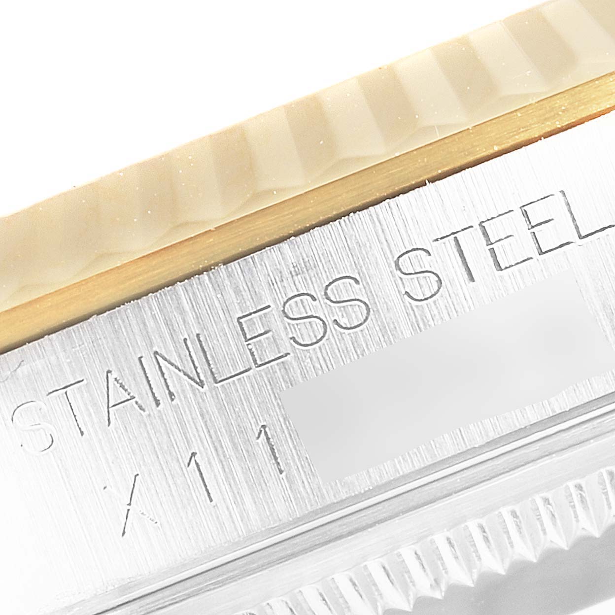 The image shows a close-up of the bezel and part of the case back with engravings on a Rolex Datejust 16233 Men's Steel and Gold (two tone) Champagne Dial 16233 Men's Steel and Gold (two tone) Champagne Dial watch.