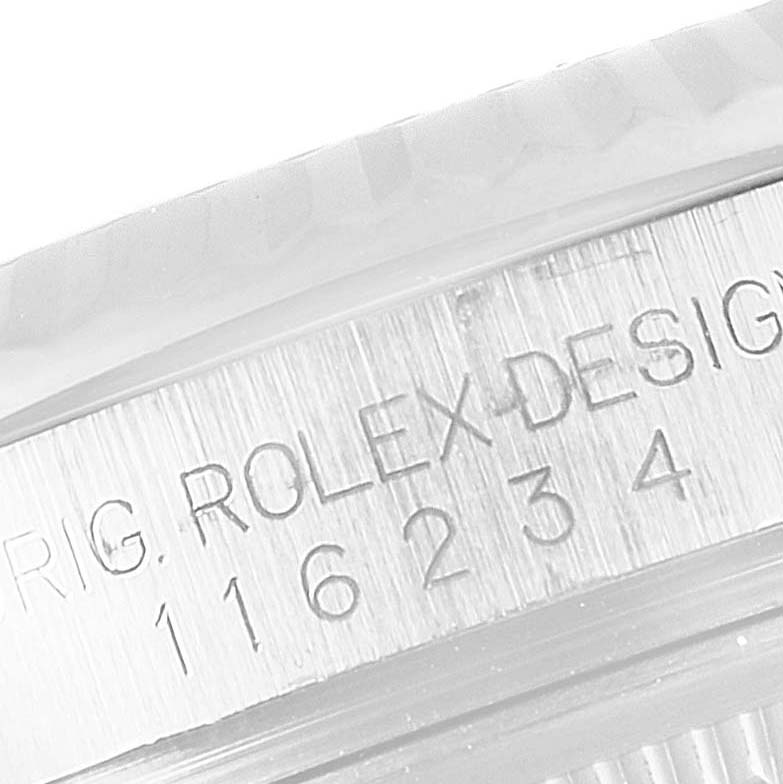 The image shows the serial number and "Rolex Design" engraving on the side of a Rolex Datejust 116234 Men's Stainless Steel Blue Dial 116234 Men's Stainless Steel Blue Dial watch.