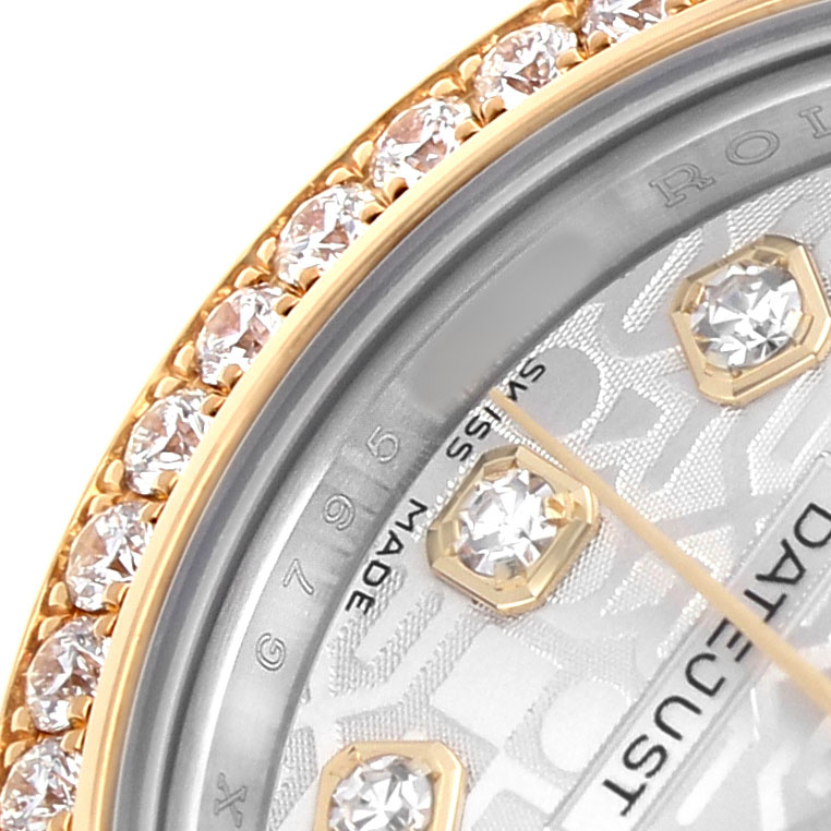 This close-up of the Rolex Datejust 179383 Women's Steel and Gold (two tone) Silver Dial watch shows the jeweled bezel, partial dial, and diamond hour markers.