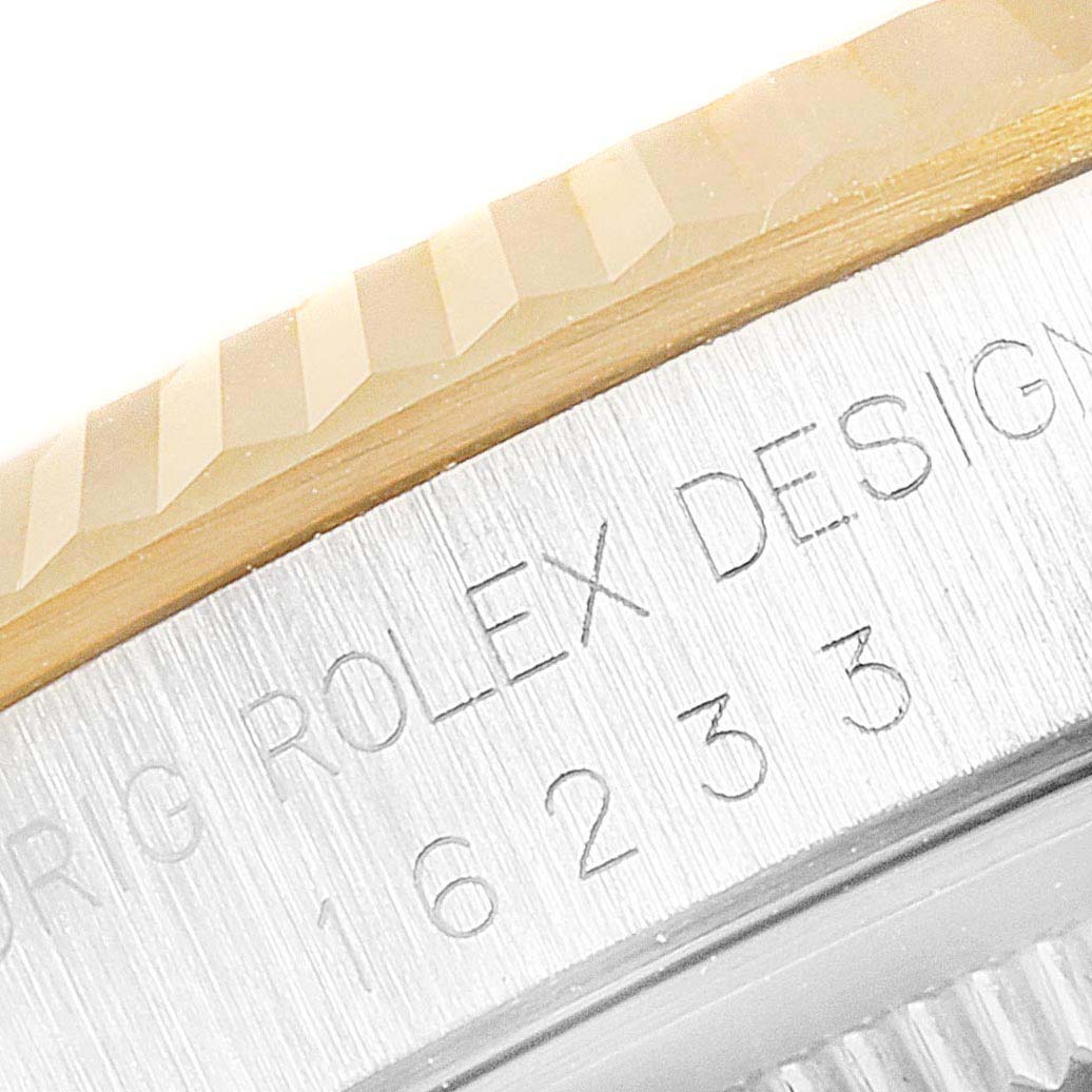 This is a close-up of the bezel and case edge, showing the engraved text on a Rolex Datejust 16233 Men's Steel and Gold (two tone) White Dial 16233 Men's Steel and Gold (two tone) White Dial watch.