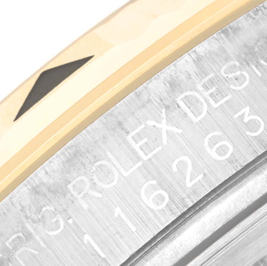 The image shows a close-up of the engraved bezel and case edge of the Rolex Turn-o-Graph 116263 Men's Steel and Gold (two tone) Champagne Dial watch.