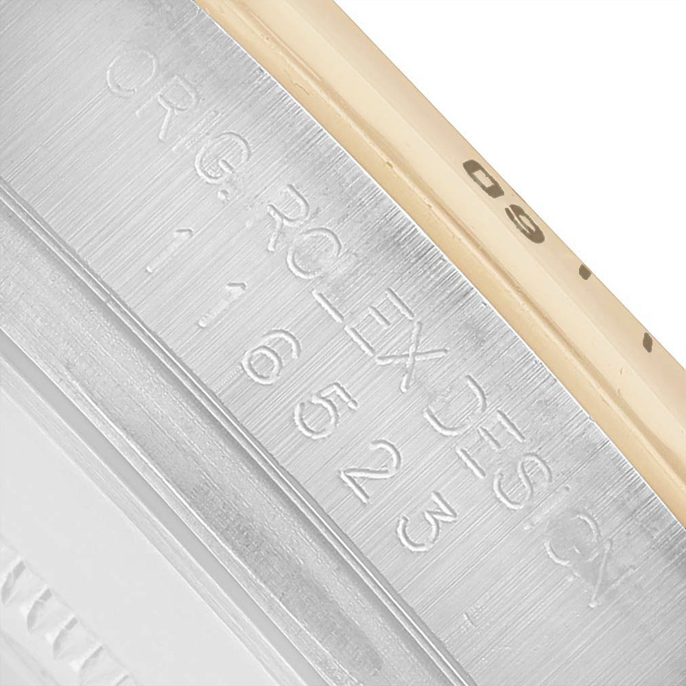 The image shows a close-up of the engraved rim of the Rolex Daytona 116523 Men's Steel and Gold (two tone) Champagne Dial watch, highlighting the serial and model details.