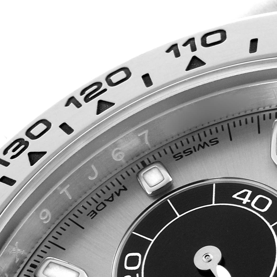 The image shows a close-up of the bezel and partial dial of a Rolex Daytona 116509 Men's White Gold Grey Dial watch, highlighting the tachymetric scale.